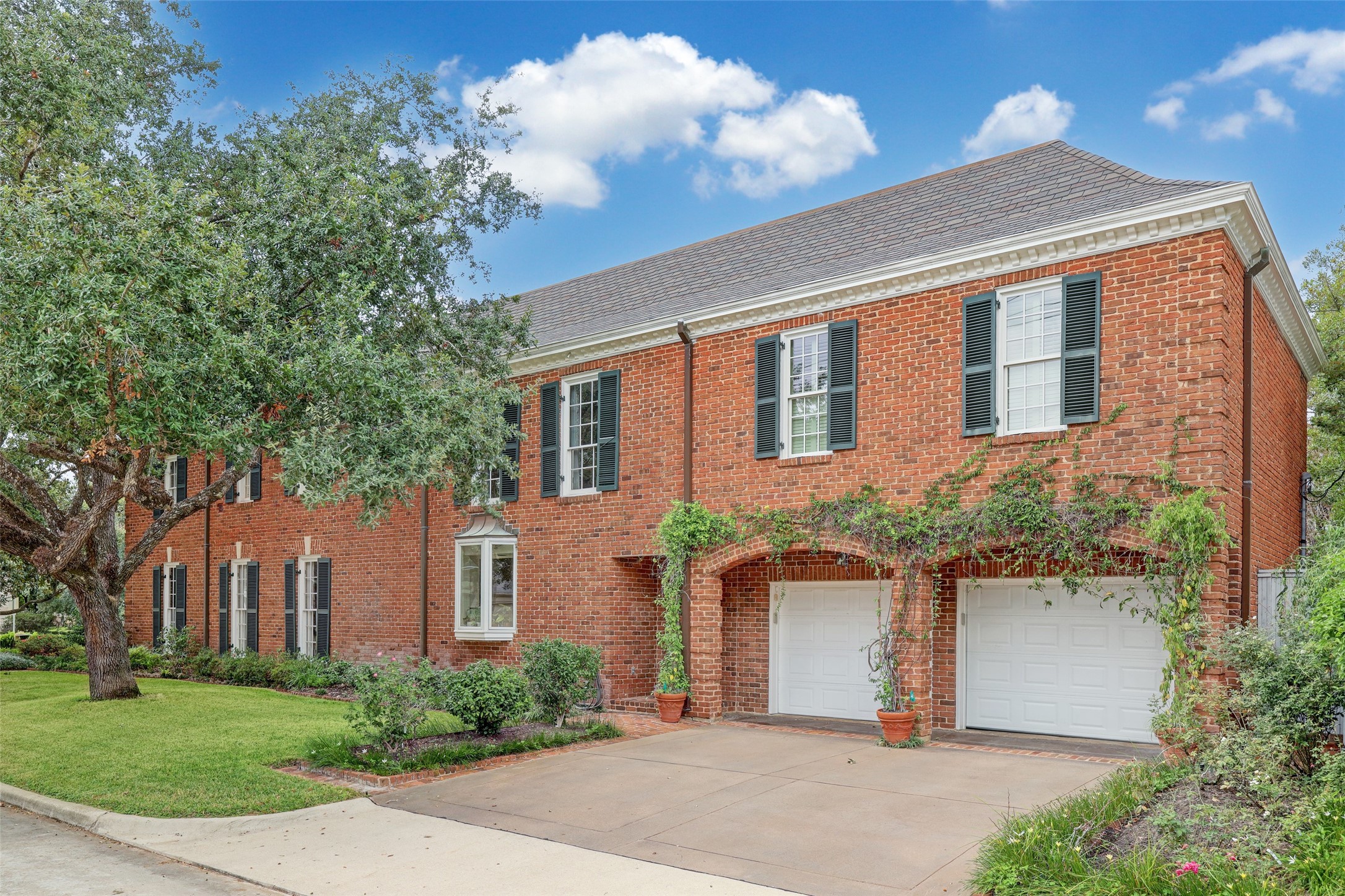Nestled at the corner of Reba Dr and Bellemeade St, this property showcases an expansive, manicured side yard, large trees, and an oversized two car garage.