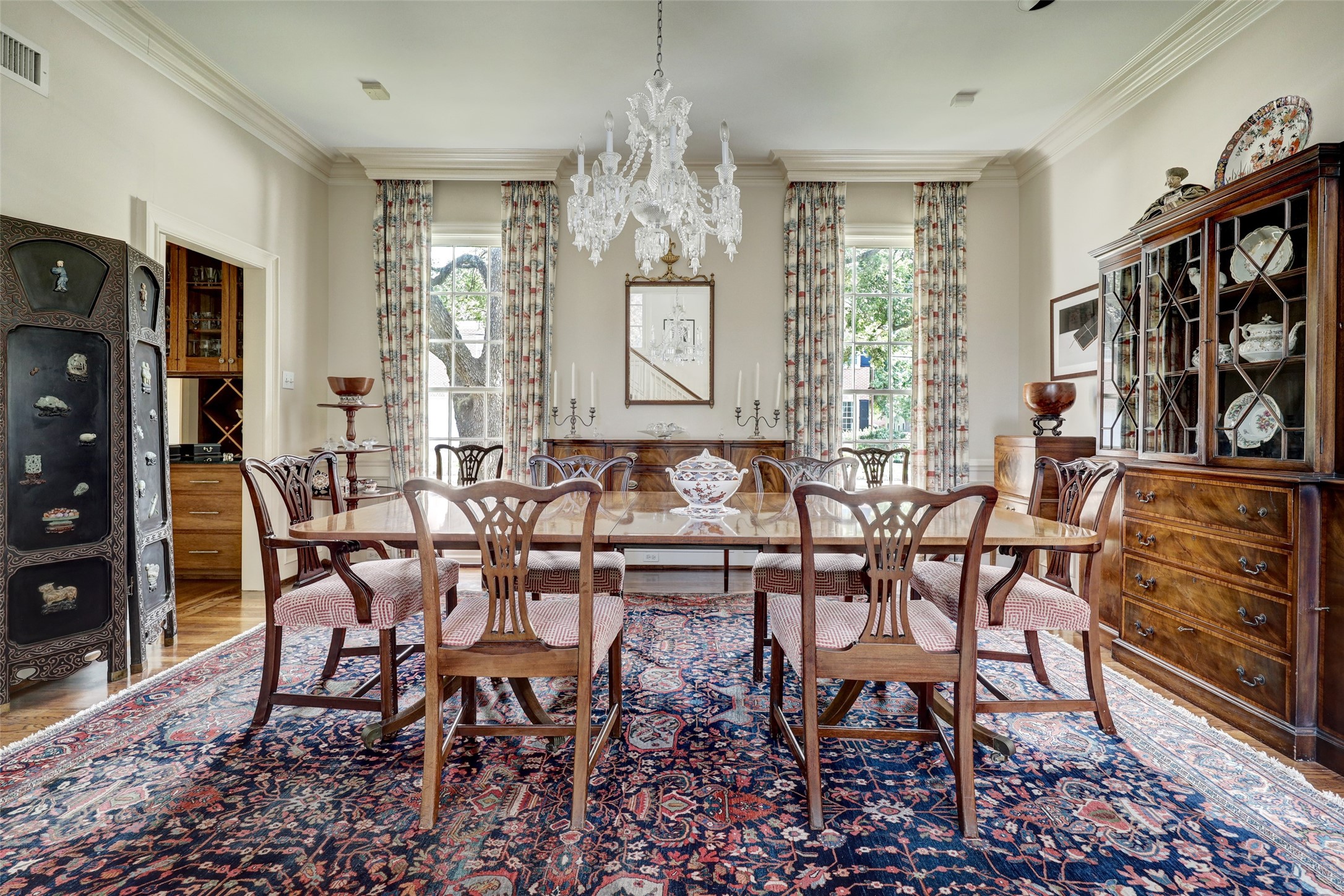 The formal dining room features large windows that flood the space with natural light, creating an elegant ambiance, and offers convenient access to the butler's pantry, making it perfect for hosting and serving meals with ease.