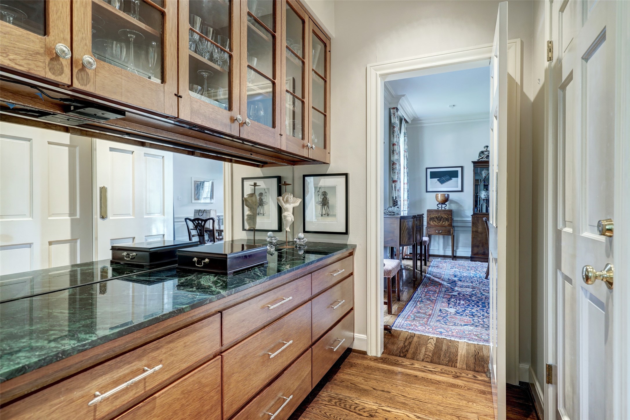 The butler's pantry, nestled between the dining room and kitchen, offers abundant cabinet and drawer storage, providing a practical and stylish space for meal preparation and storage needs.