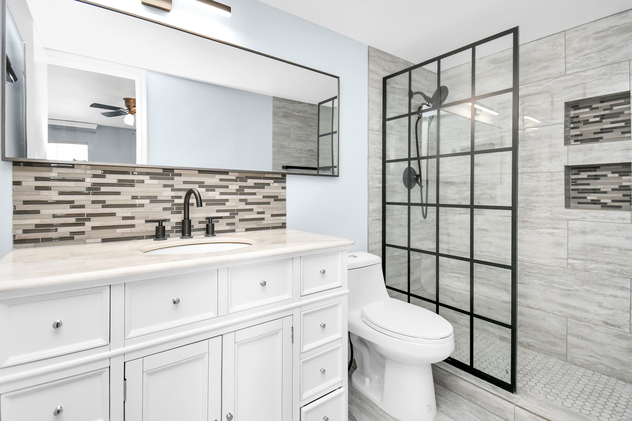 It is a Hollywood Style Bathroom with Glass Door Standing and Shower and Soft Close Cabinets.
