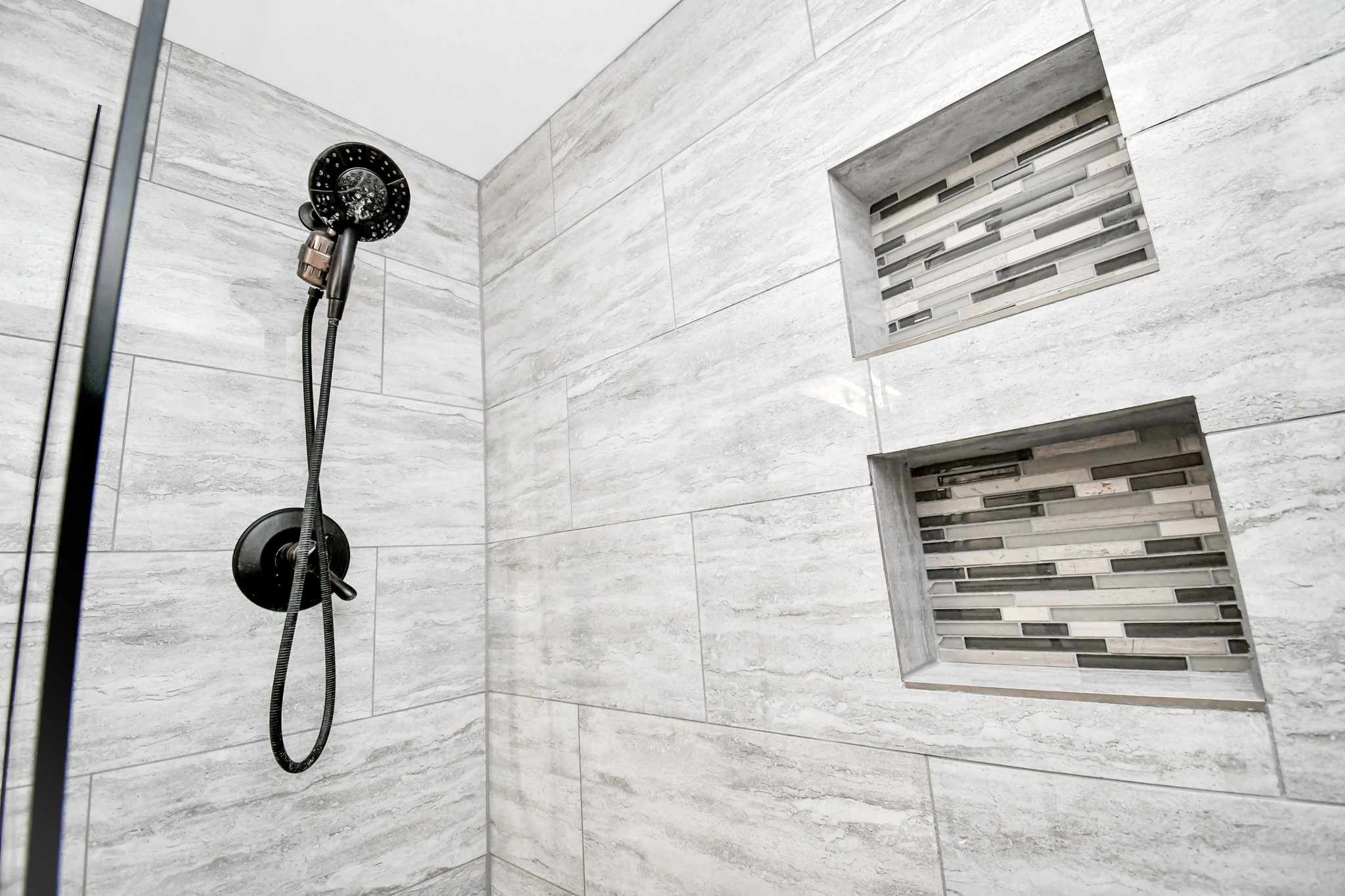 Shower has all around beautiful tiles wall,