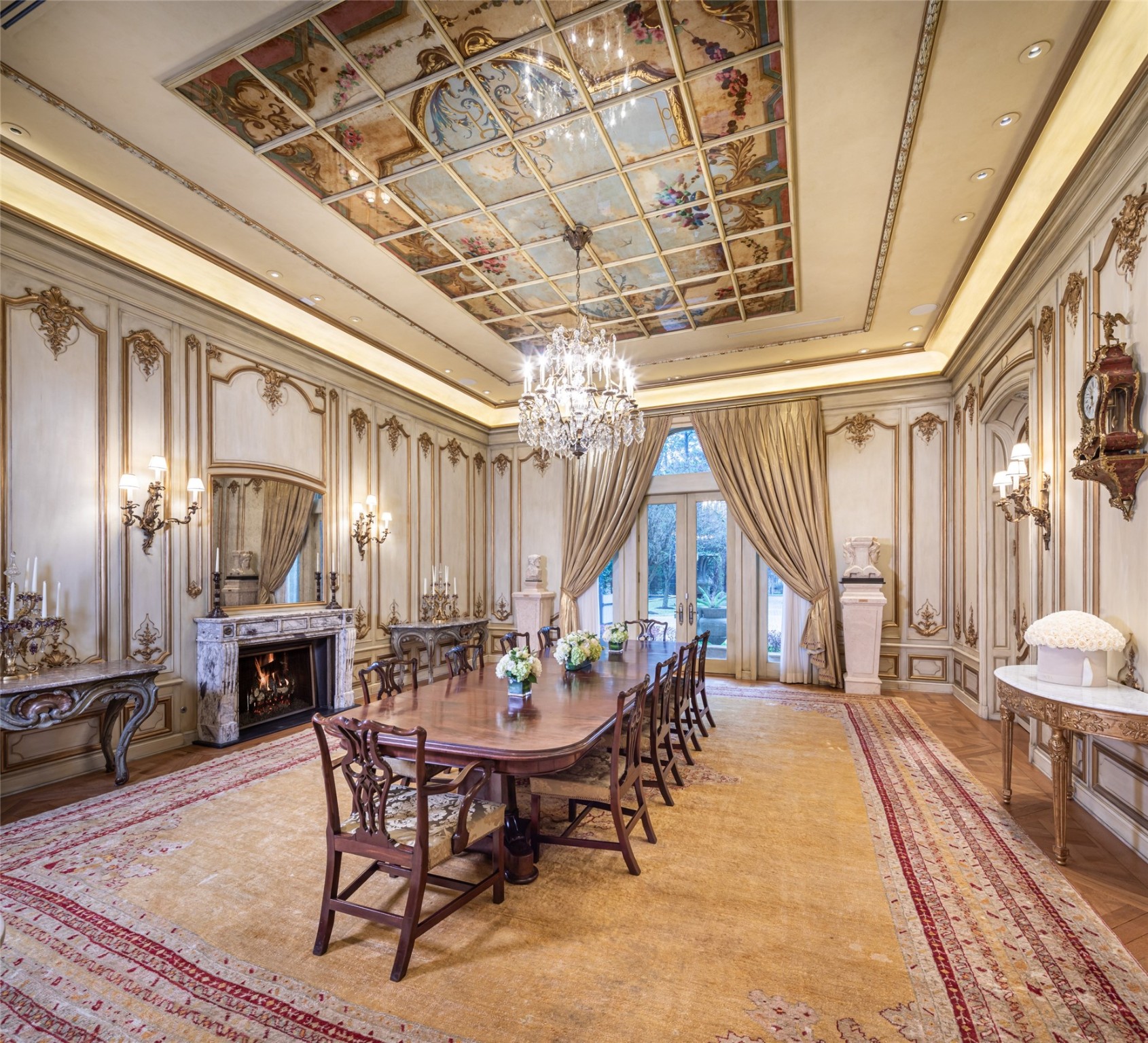 Guests will be amazed as they enter the Formal Dining Room with 14' custom ceiling of antique hand-painted canvas panels imported from Europe, overlaid with glass and bound within a custom carved wood border accented by metallic glazed reed and ribbon garland.