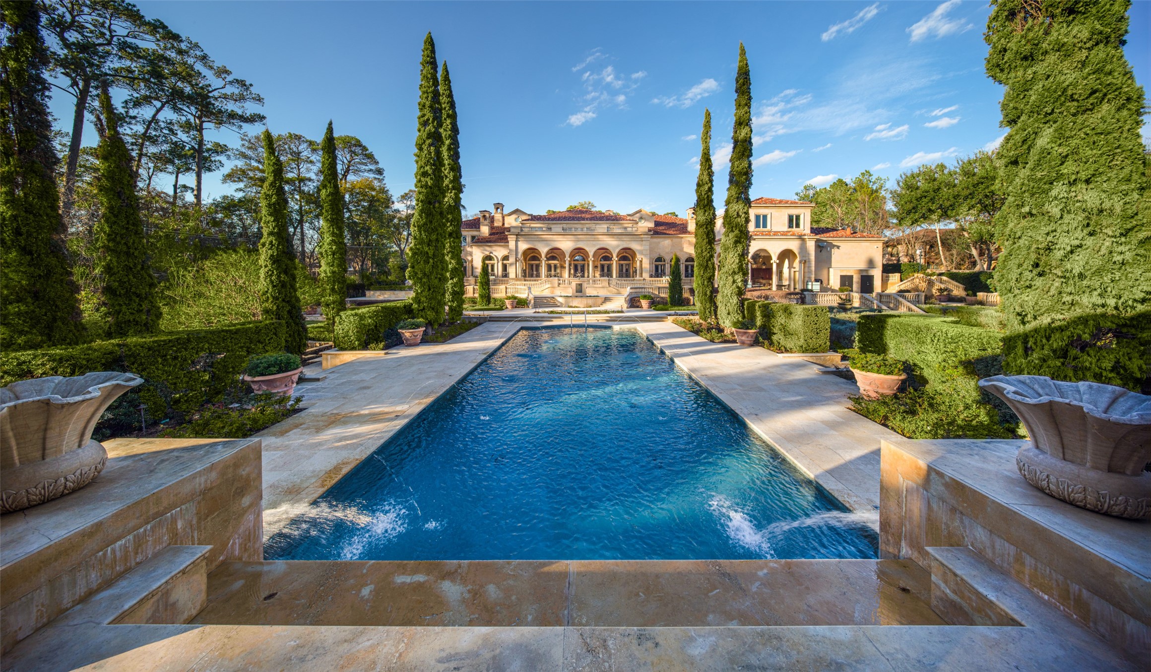 A centerpiece Parisian-styled Pool flanked by soaring arborvitae anchors the rear grounds of this magnificent 2.32-acre estate; conceived as Les Tuileries, with tiered marble terraces and staircases, overlooking a verdant wonderland below, all designed to transport mind and spirit. Home  Sweet Home at The Estate at 100 Carnarvon