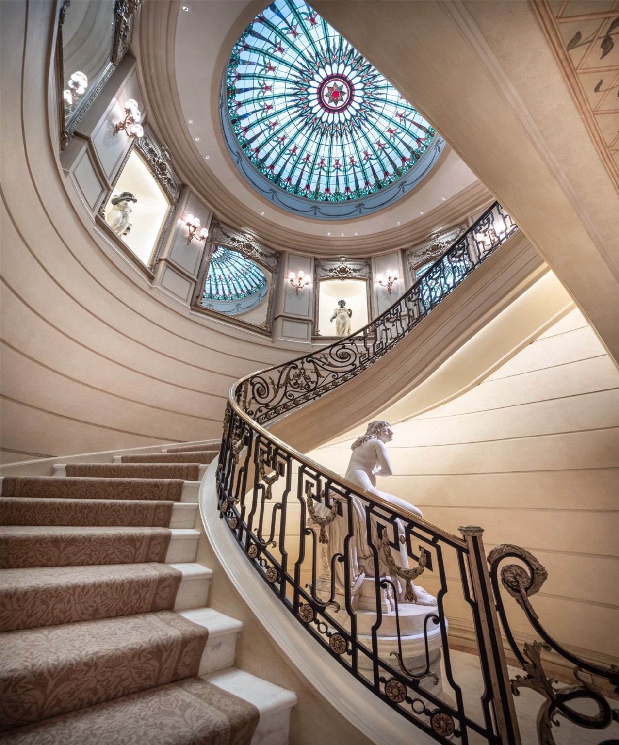 Architectural beauty! A stained glass domed ceiling inspired by Tiffany rises above the grand Stair Hall.