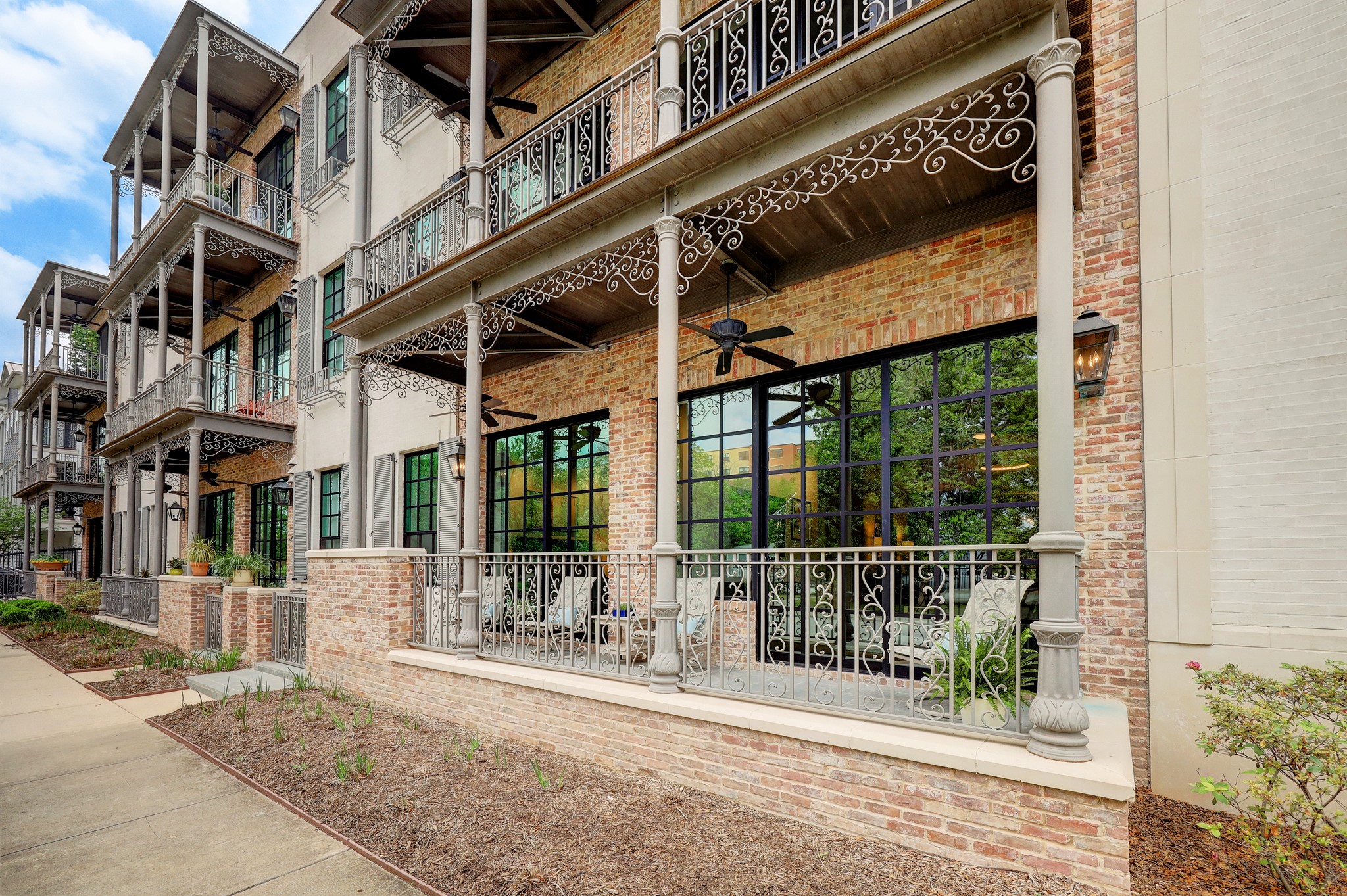 The elegant first floor New Orleans style condo in Bell Heights! When you walk in your breath will be taken away by the 13 ft. ceilings, the magnificent use of modern finishes with exposed original concrete, and the gorgeous floor to ceiling windows leading to a covered patio.