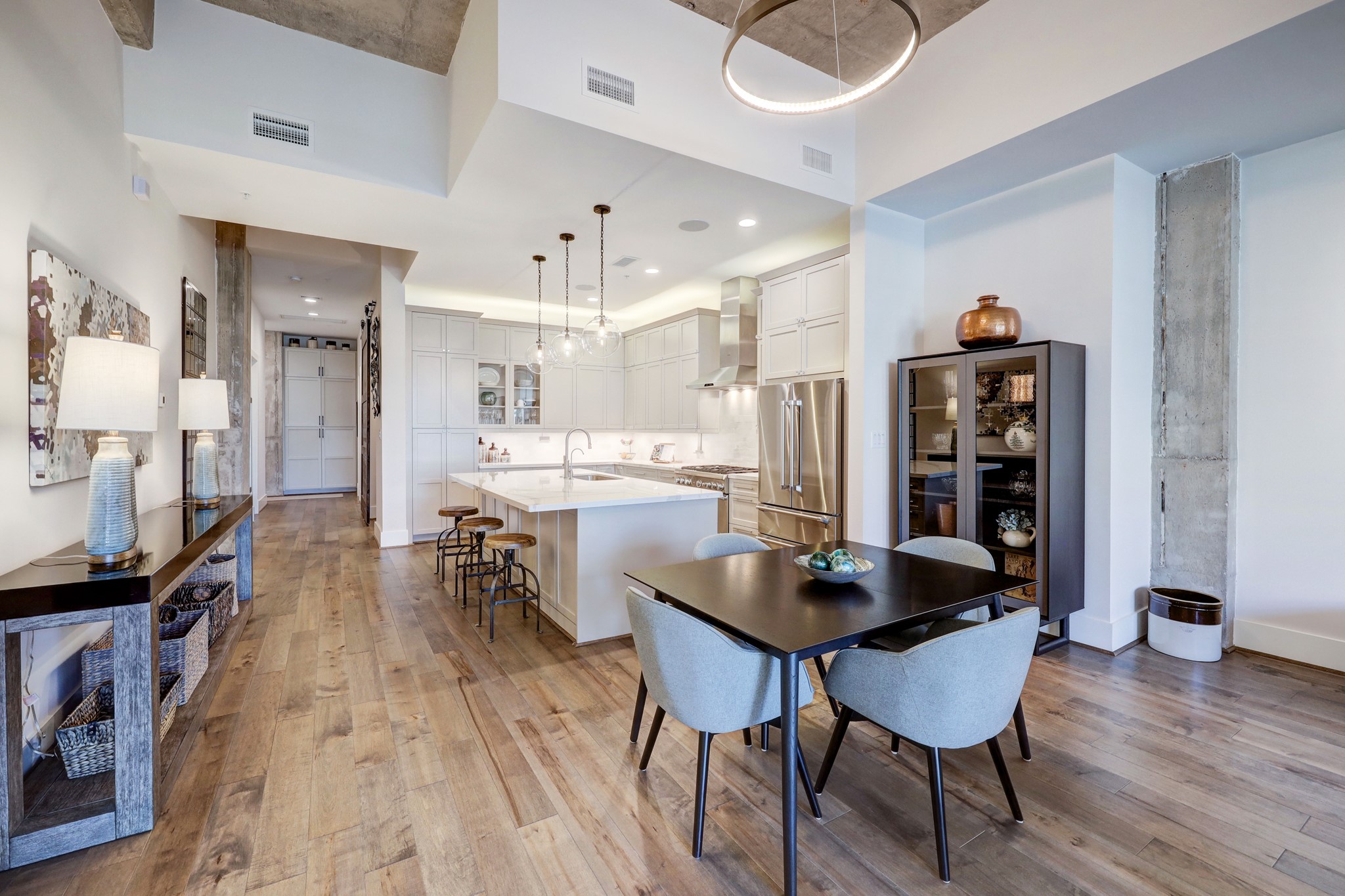 A Circa Bodiam chandelier and Circa globe pendants highlight the kitchen and dining room. You will love the openness of this space! Excellent for entertaining and everyday life.
