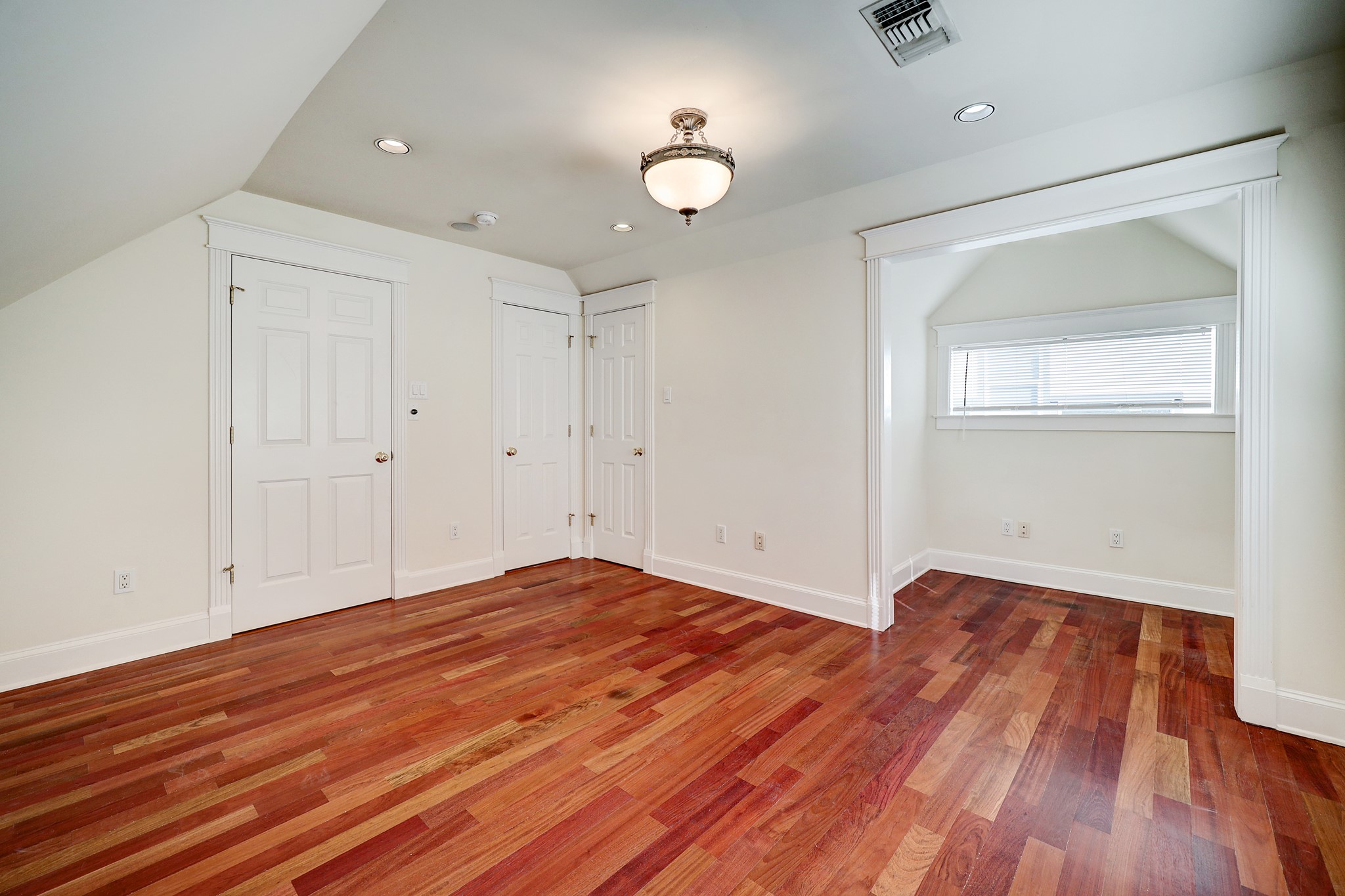 Located on the second floor, the first of the two secondary bedrooms offers large windows that allow natural light to stream in, hardwood flooring, and ample closet space.