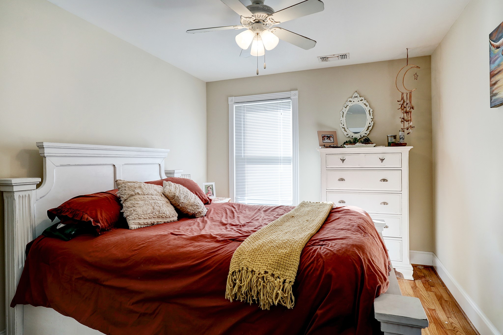 The garage apartment bedroom offers beautiful hardwood flooring, neutral colors, 6-inch baseboards, and ample closet space.