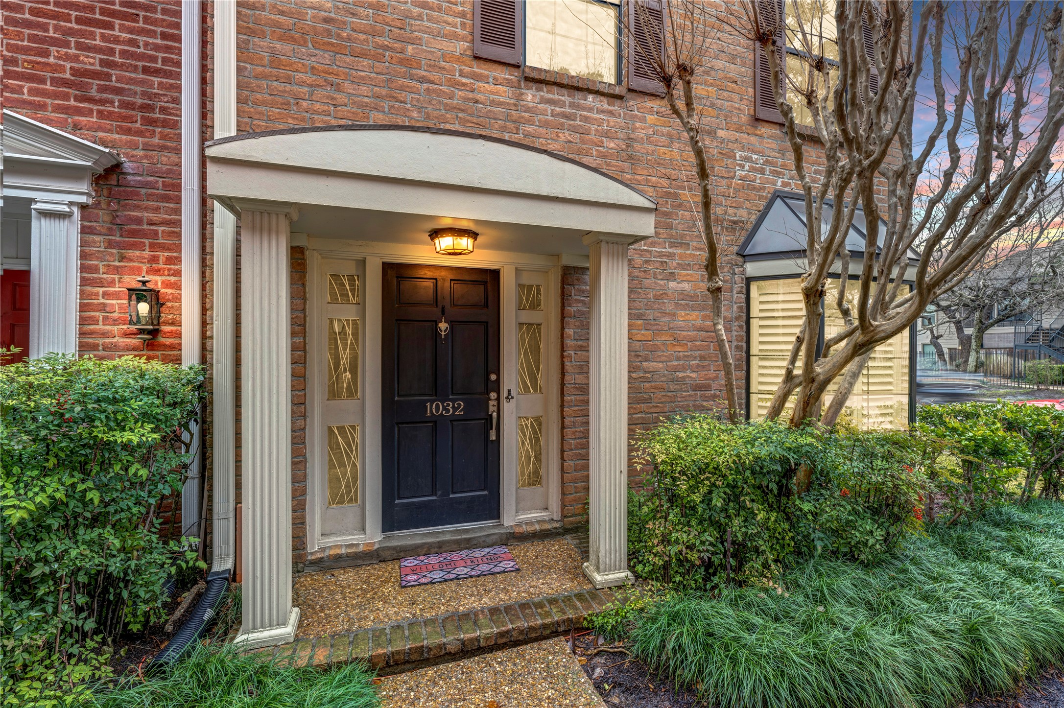 The front elevation of the building provides ample guest parking and is strategically positioned within the complex. A charming covered porch and meticulously crafted professional landscaping make for an inviting and hospitable entryway.