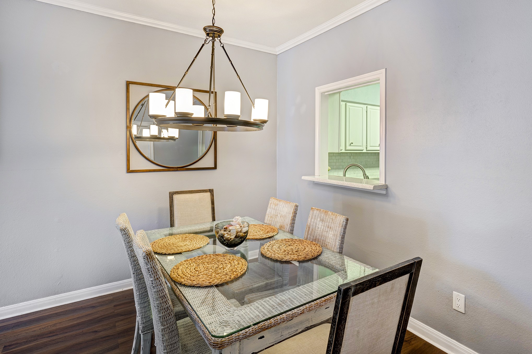 One's gaze falls upon the charming dining area that offers a glimpse into the adjoining kitchen, while the capacious family room, although not captured in the photograph, is also present.
