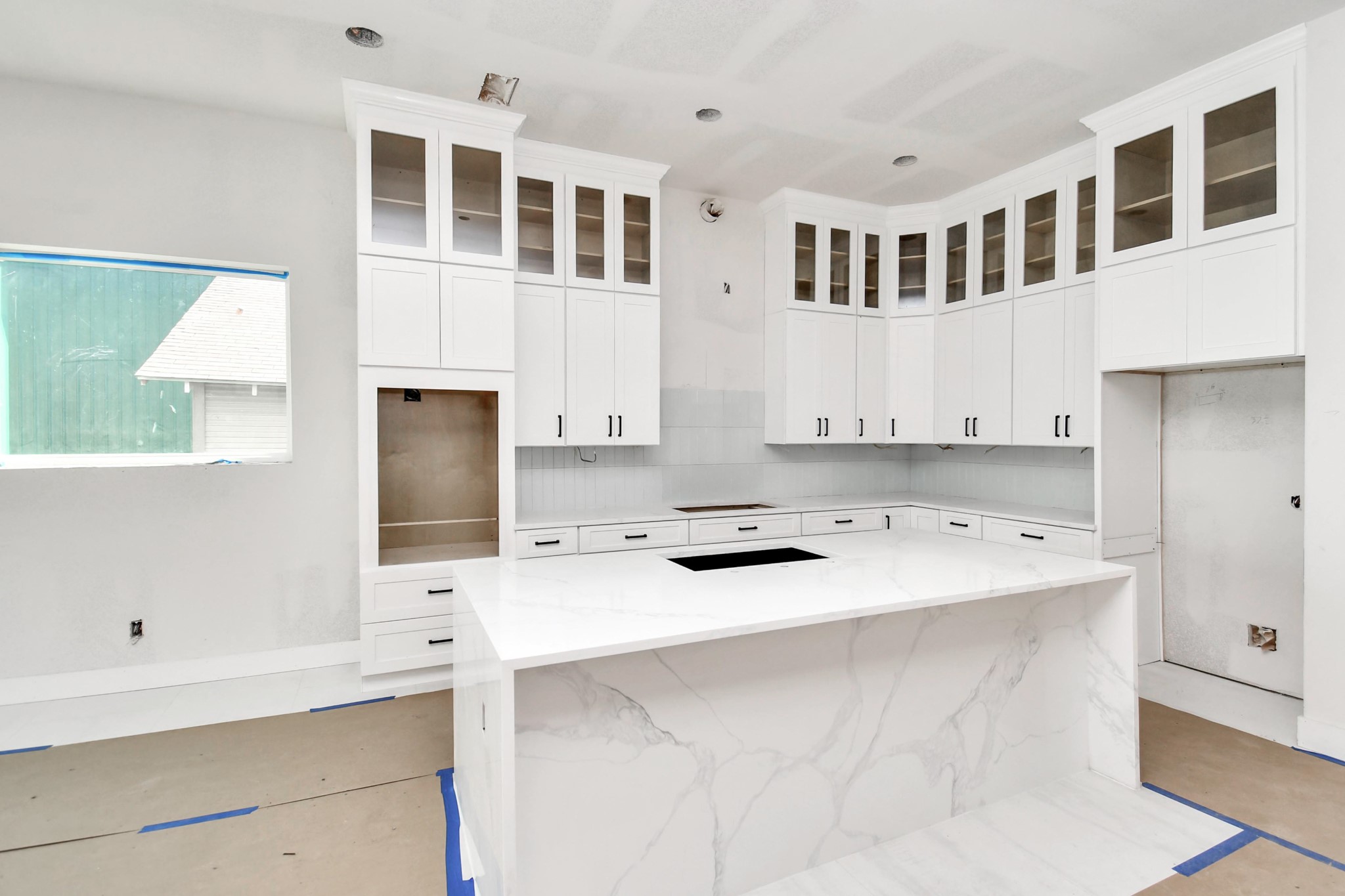 The custom cabinetry and waterfall island are one of the many luxe details this home possesses.
