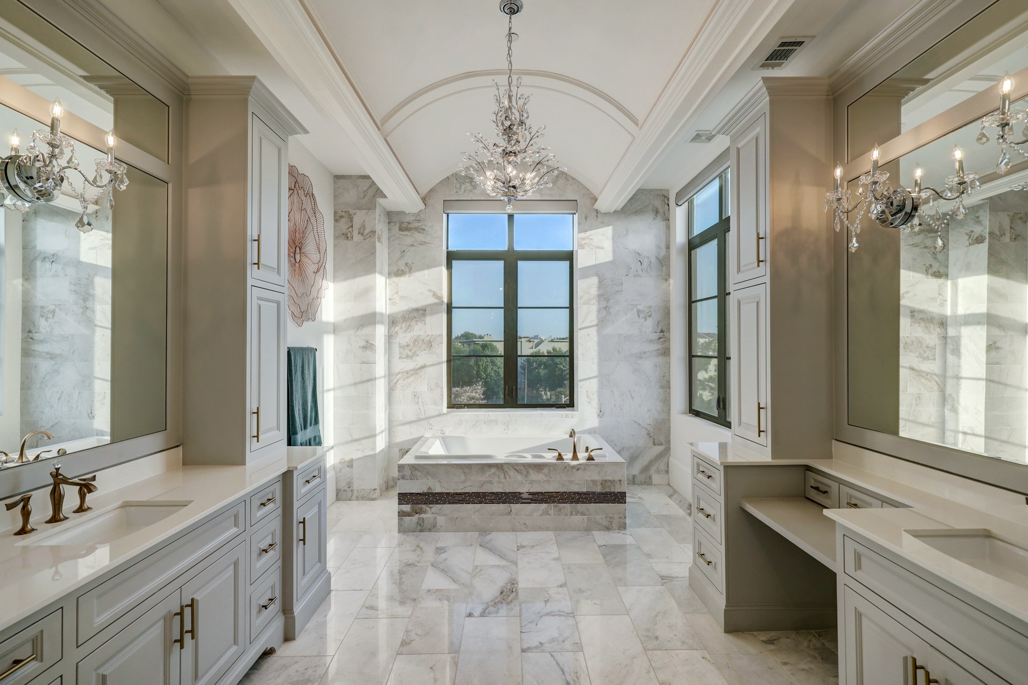 Dual sinks, make up vanity and picture windows are featured in the primary bath.