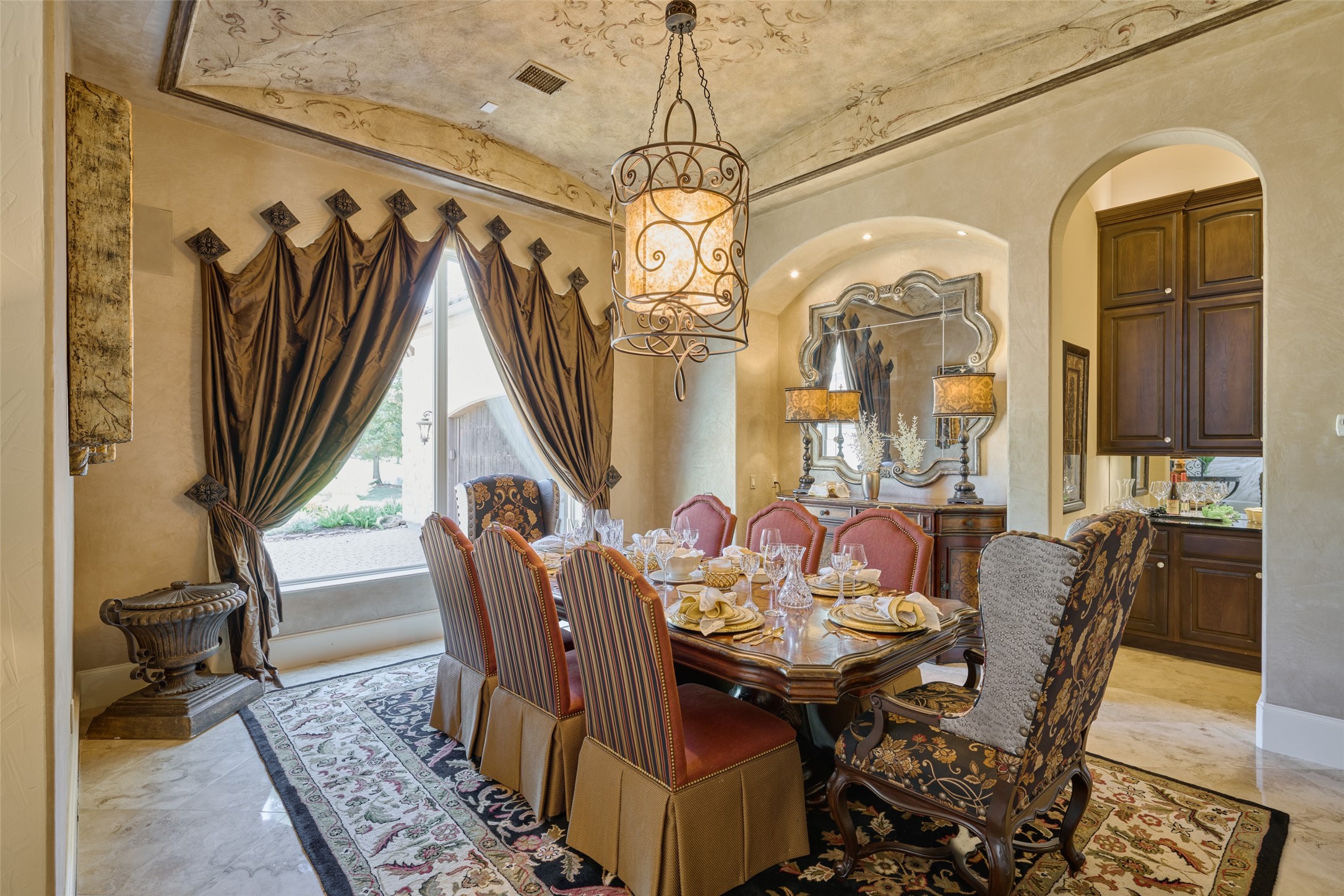 Formal dining room with street views is to the left of the front doors, and has custom-painting, custom draperies, and a separate butler pantry.  All furnishings in home including draperies, art, lamps, etc. are all included.