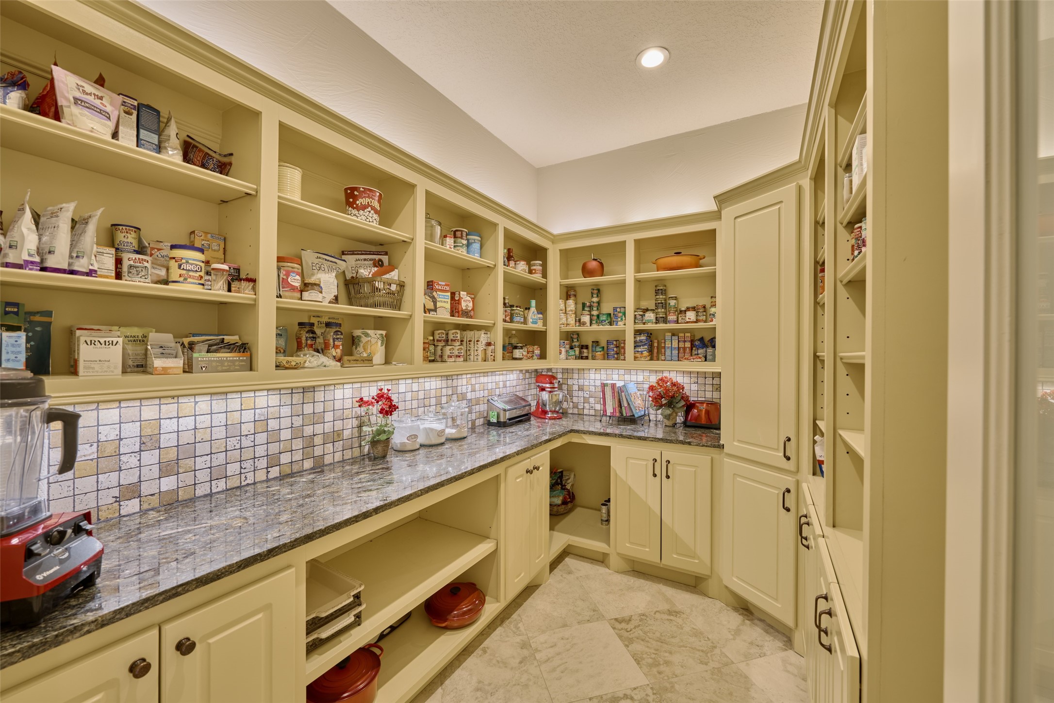 A walk-in pantry for the record books...  With open shelving, abundant cabinet space, granite counters, lots of storage space for large appliances, seasonal and entertaining cookware, platters, outlets to utilize your Vitamix or other accessories inside the pantry and larger kitchen items.  This panty is 7 X 11 - larger than most closets, abundant space to store all of your pantry items and more!  Above and under counter lighting.