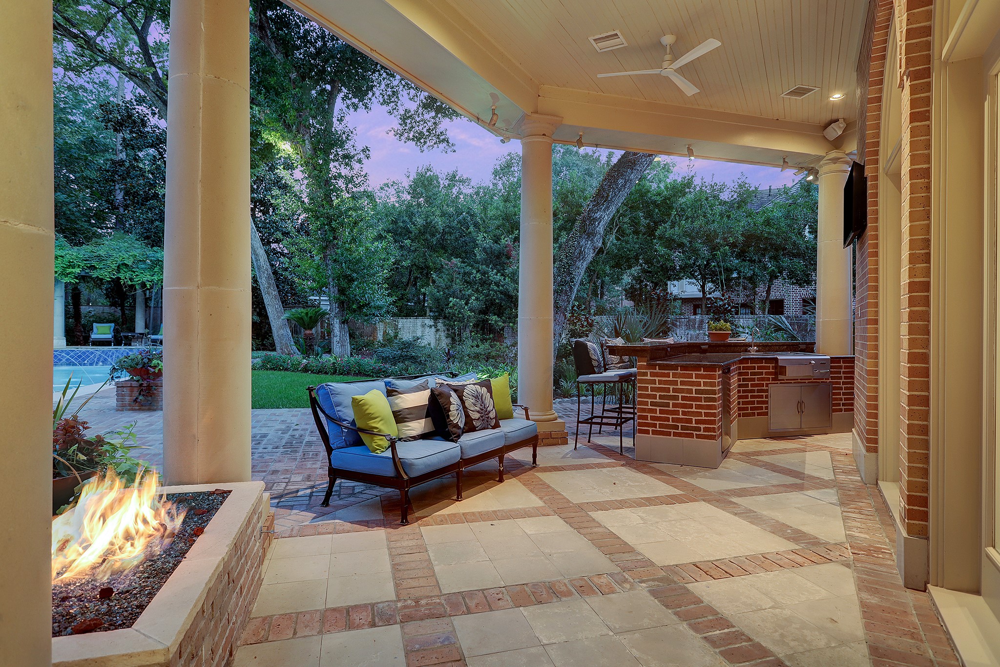 Covered outdoor living area with gas fire feature.