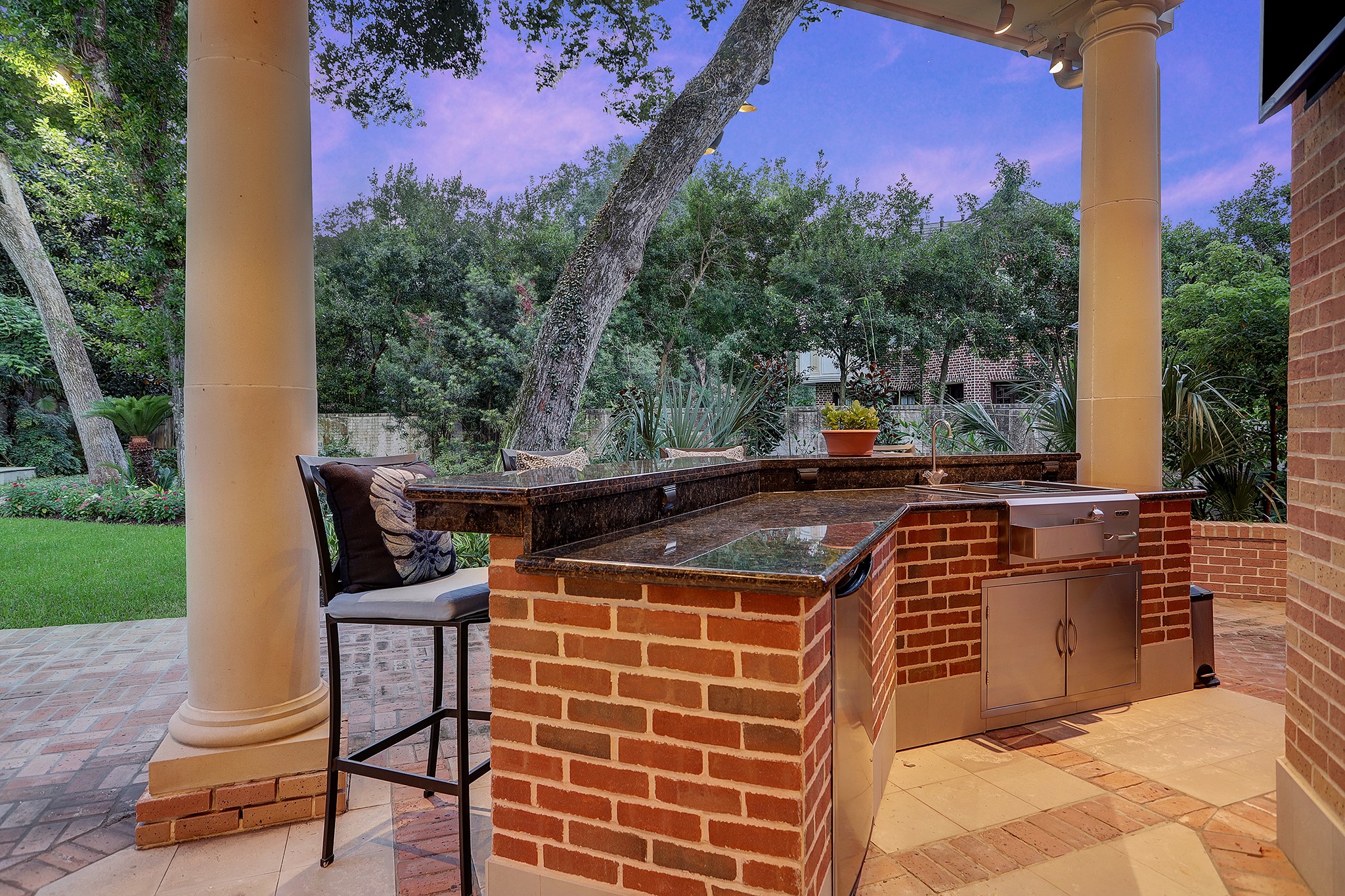 Outdoor kitchen with built-in Calise gas grill and LUXOR sink.