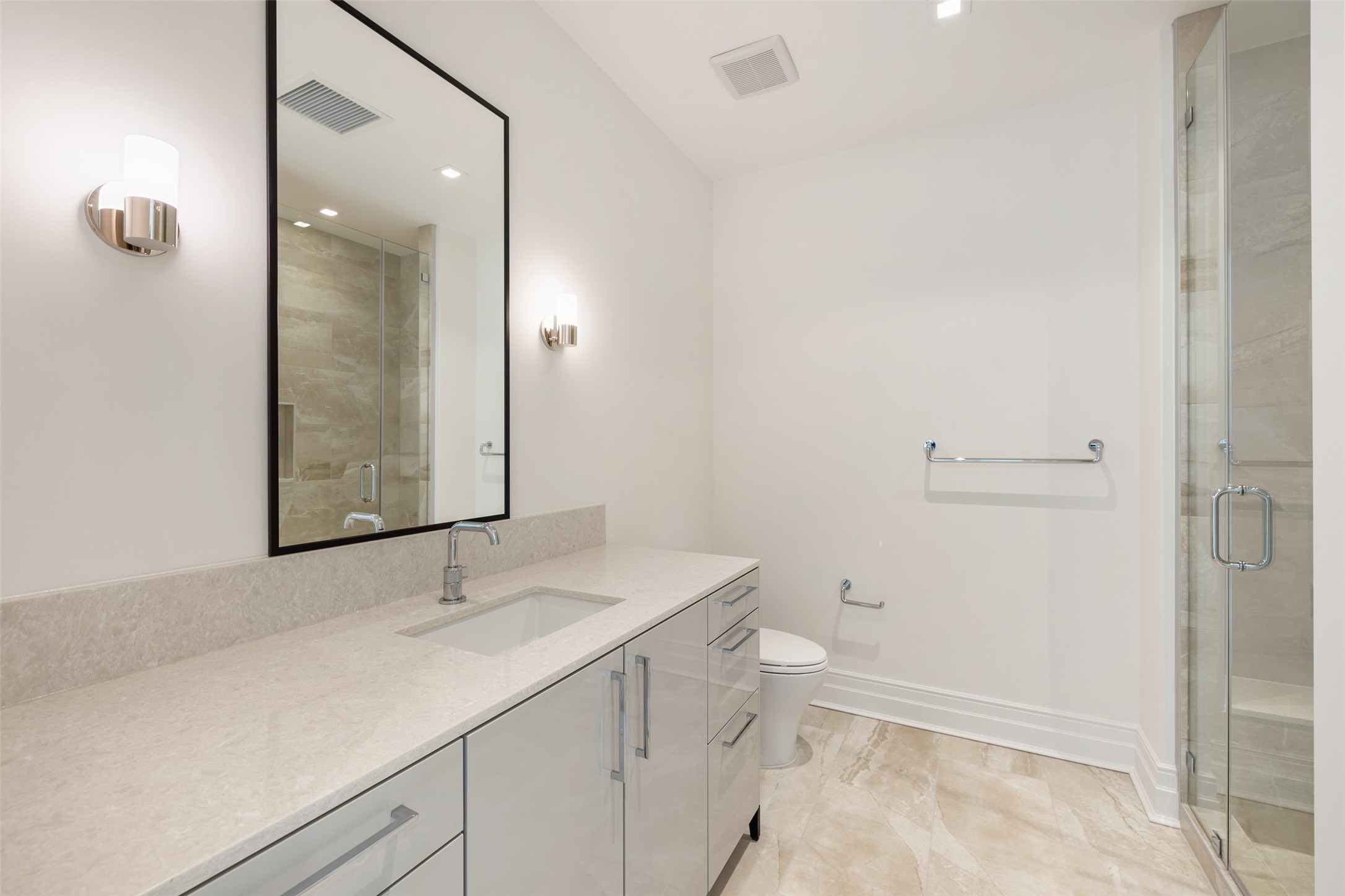 This Secondary Bathroom features high-end fixtures and a walk-in shower.