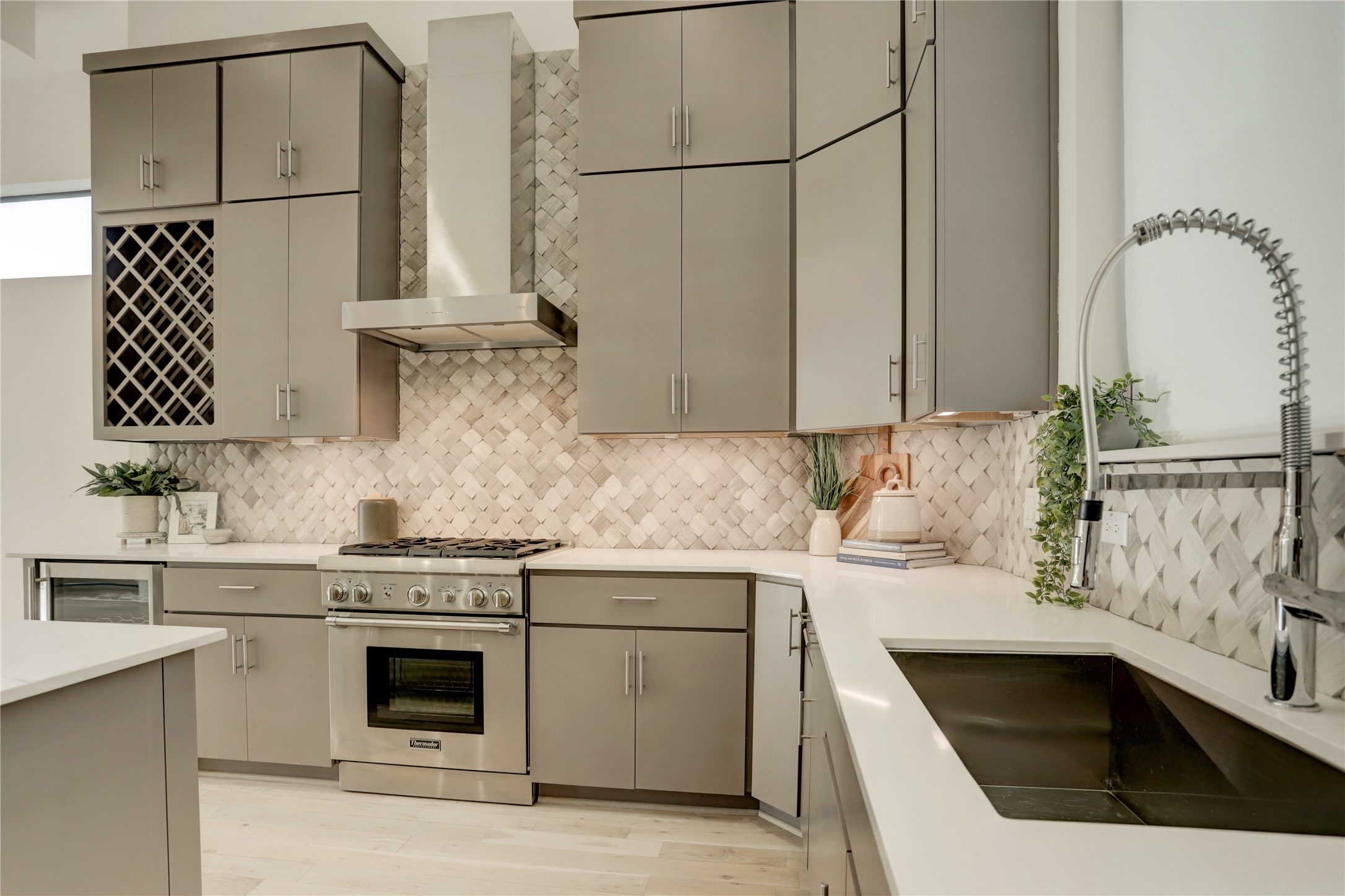 Crafted with precision and attention to detail, the custom cabinetry offers both ample storage and a touch of elegance and is highlighted by the sophisticated backsplash which adds the perfect touch of interest to the space.

