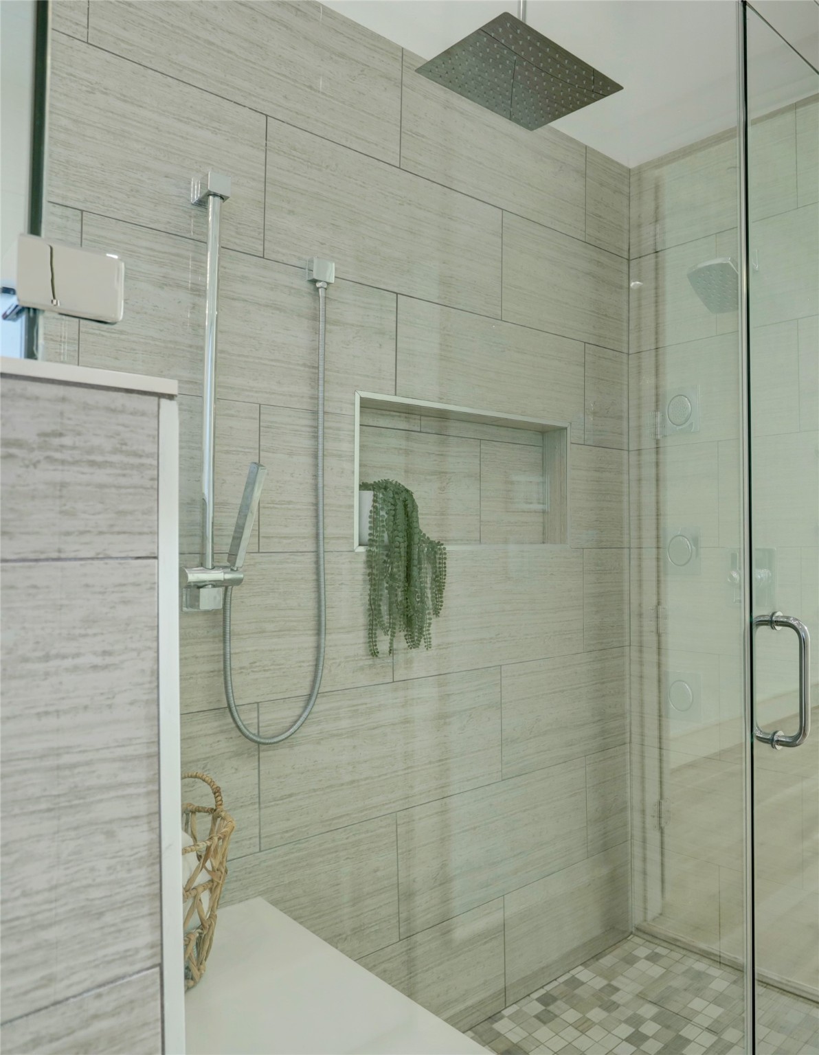 This walk-in shower is incredible with a luxury feel, multiple shower heads, and ample drainage options.