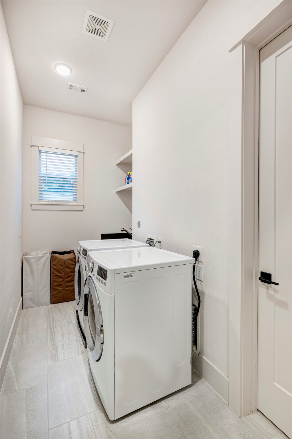 Laundry room is located upstairs and has entrance from the hallway and the 2nd walk-in closet of the primary bedroom. Soaking sink too.
