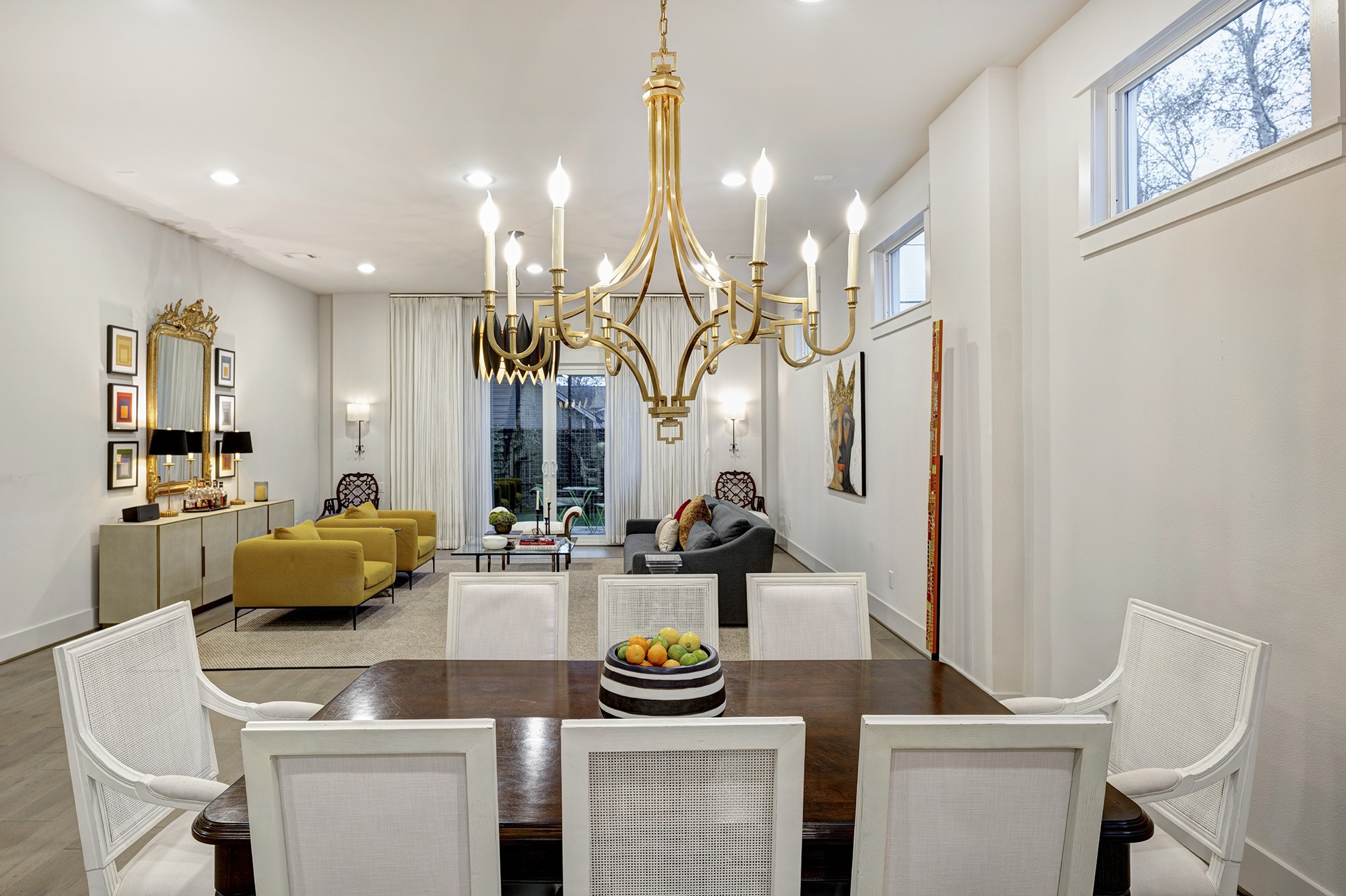 Centered between the kitchen and living room, the dining area is anchored by this striking Mykonos by E.F. Chapman chandelier.