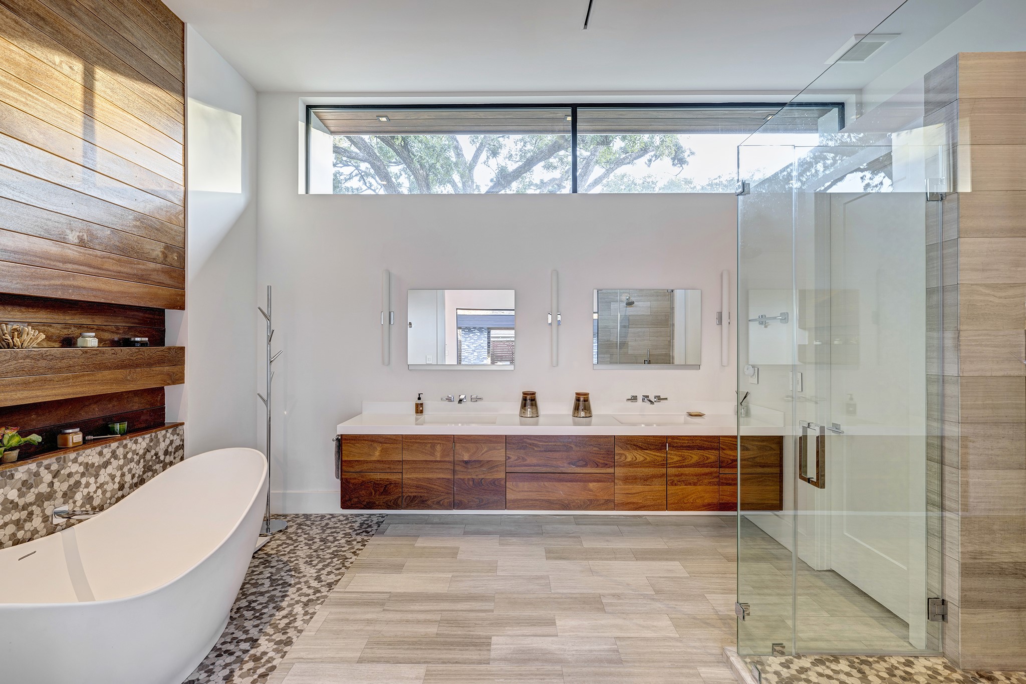 Luxurious primary bathroom is a spa-like feel with soaking tub, dual sinks and walk-in shower.
