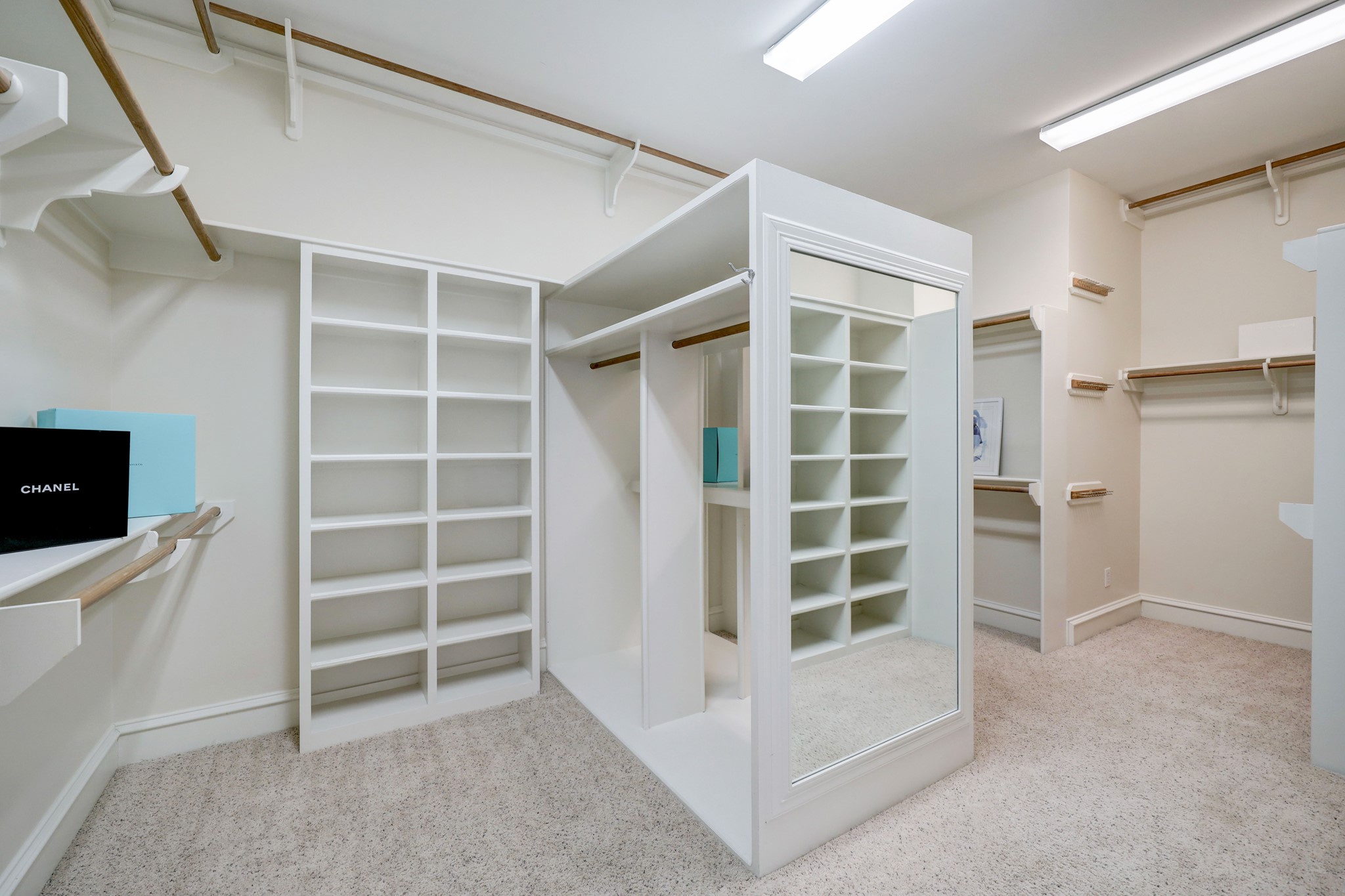 The walk-in closet features a myriad of shelving and hanging options for both sides of an extensive wardrobe.