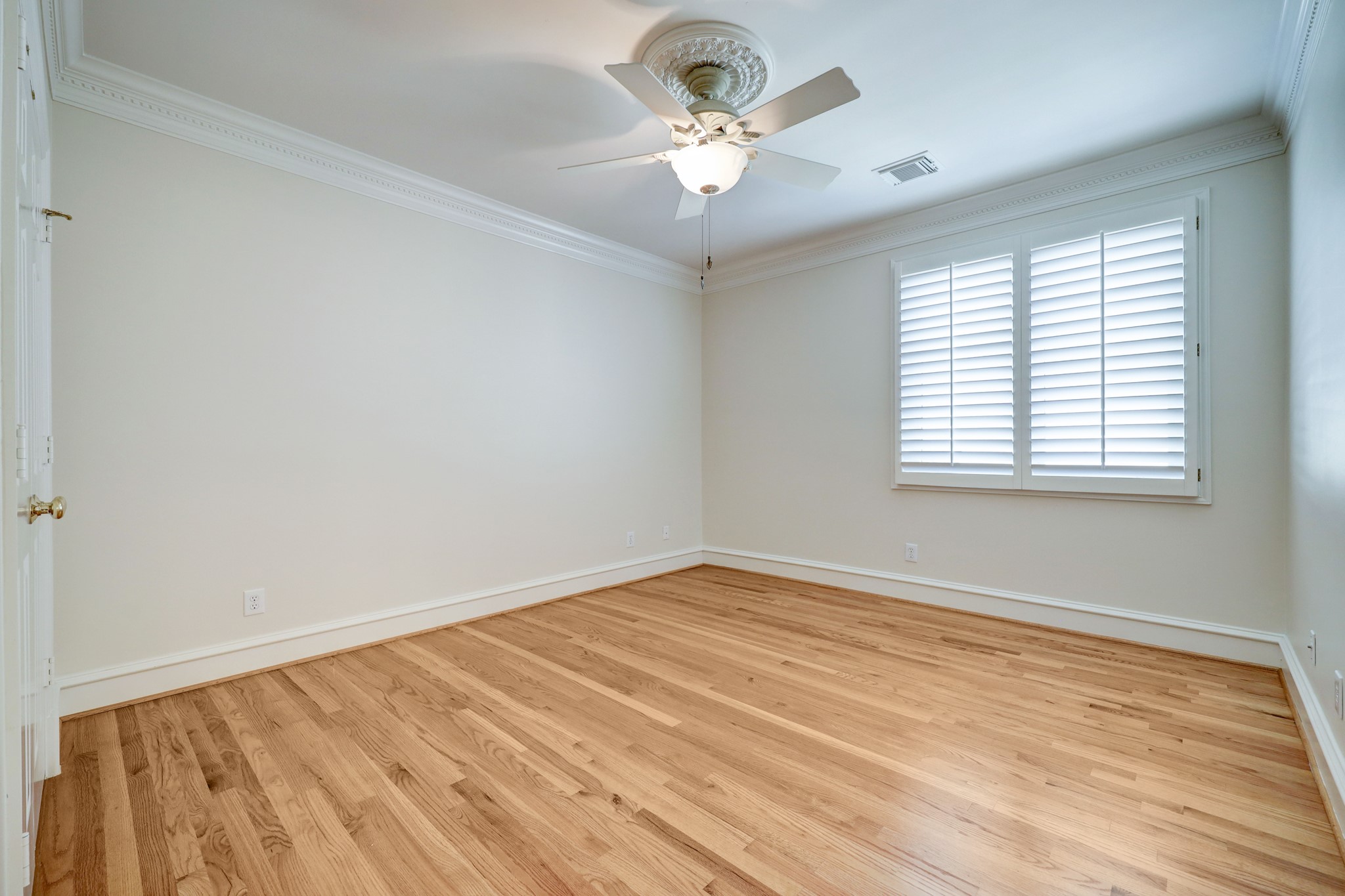This is bedroom 5 which again has the hardwood flooring, plantation shutters, and nice closet storage.