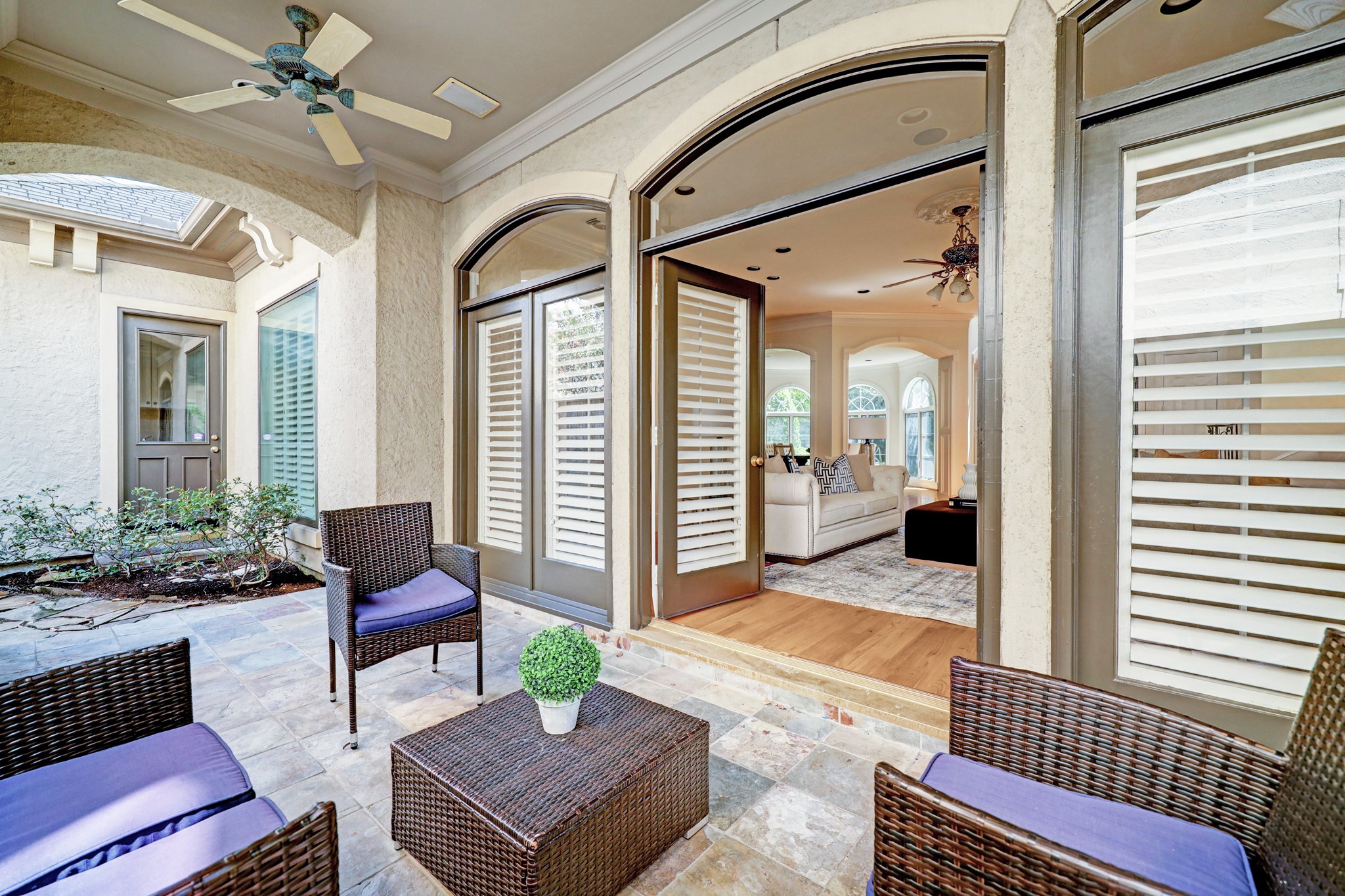 French doors from the living area lead out to this comfortable lighted covered patio w/ ceiling fans and sound speakers.  It is perfect for those cool nights to come when you can sit out and enjoy a beverage and conversation.  Have your friends over.