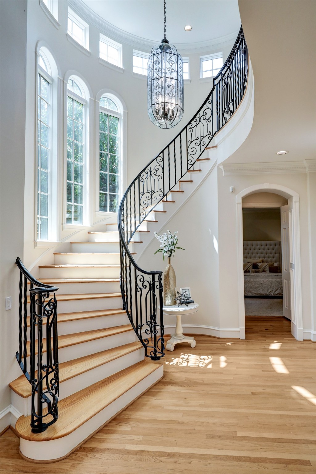 The sweeping staircase is dramatic and light-filled.