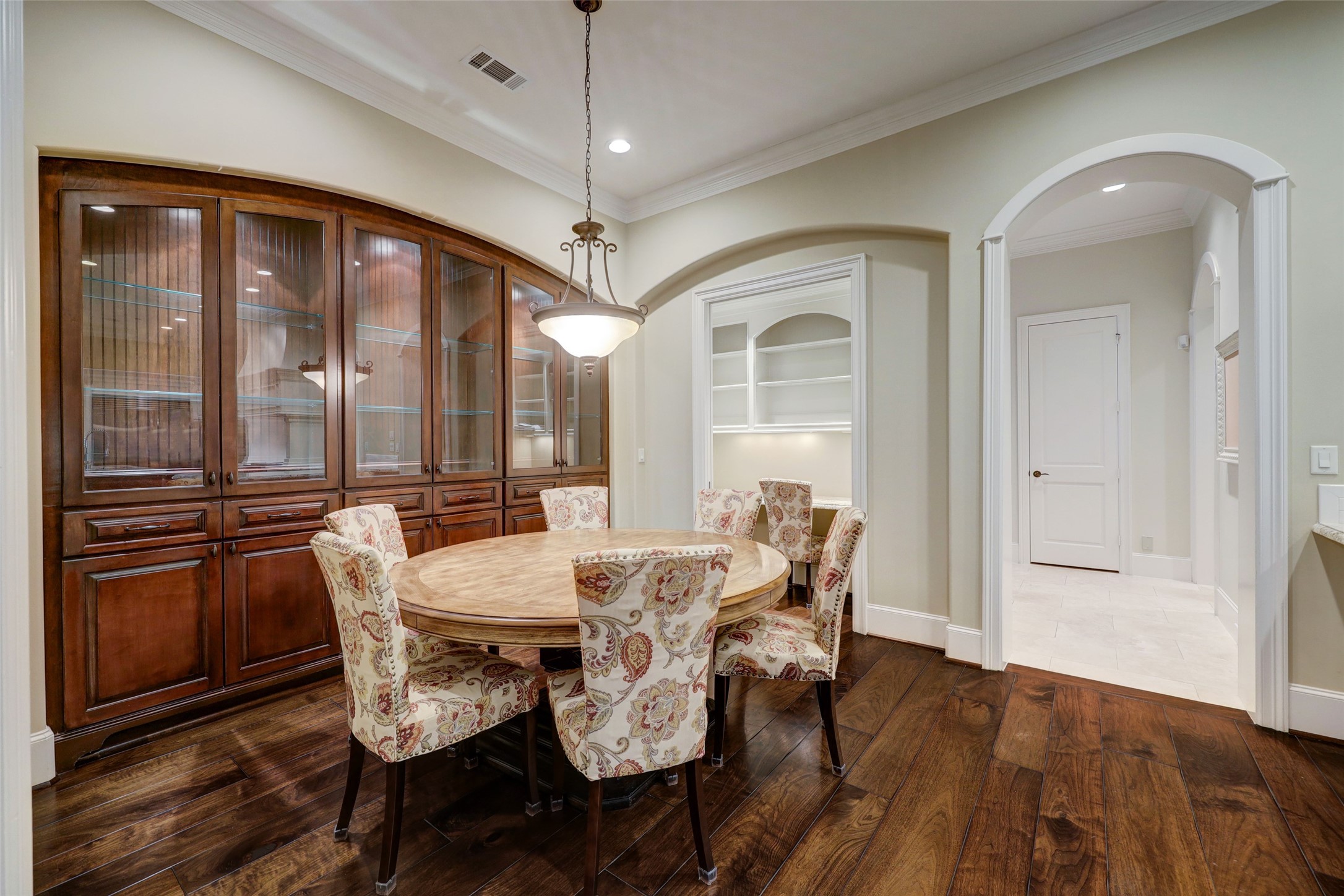 Aside the Kitchen is an eat-in Breakfast Room featuring a large built-in Breakfront, plus a Command Center that disappears behind nifty pocket doors.  To the right of frame is...