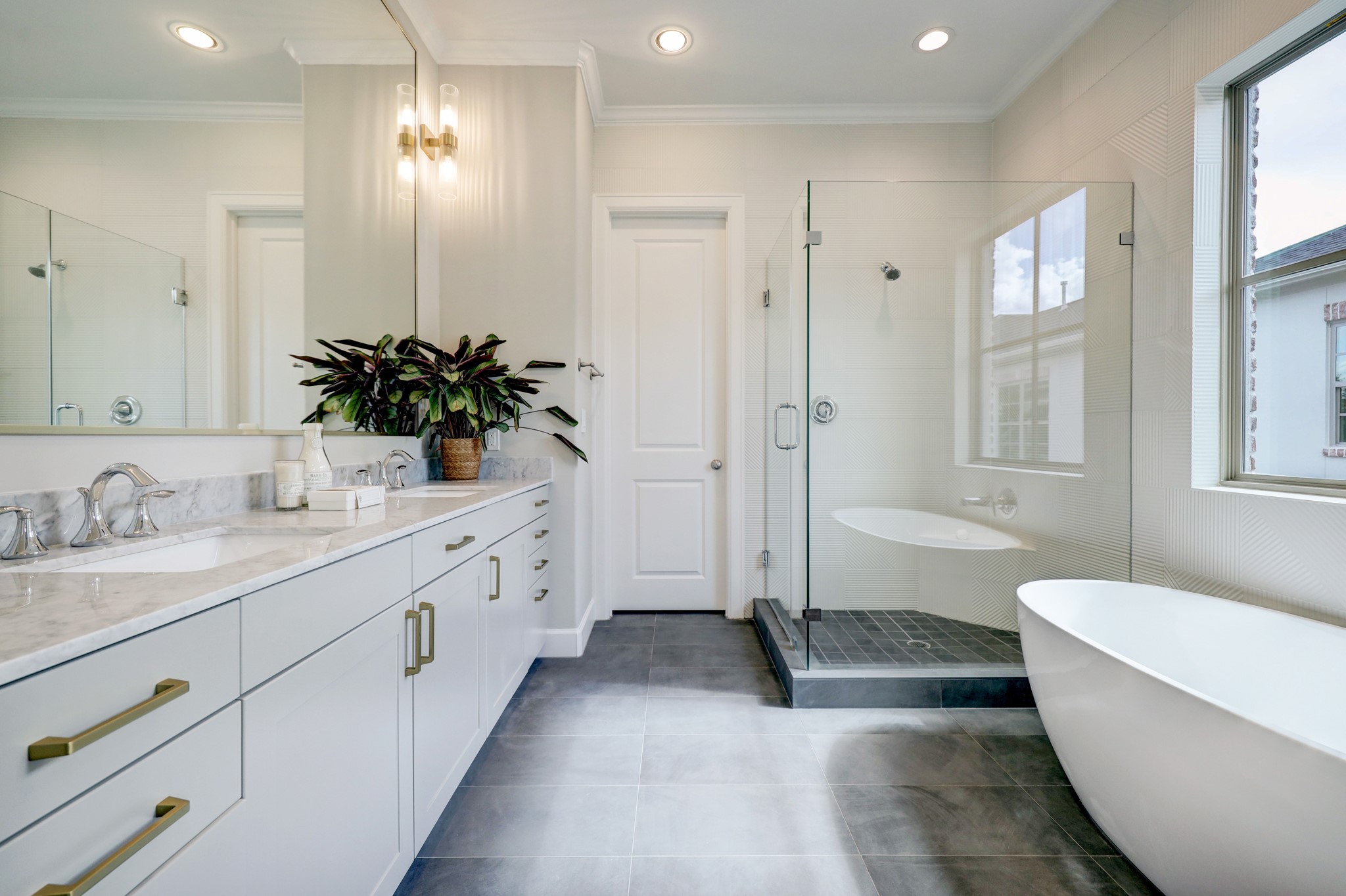 Relaxing Primary Bath with double
sinks, separate water closet, oversized
walk-in shower and soaking tub.