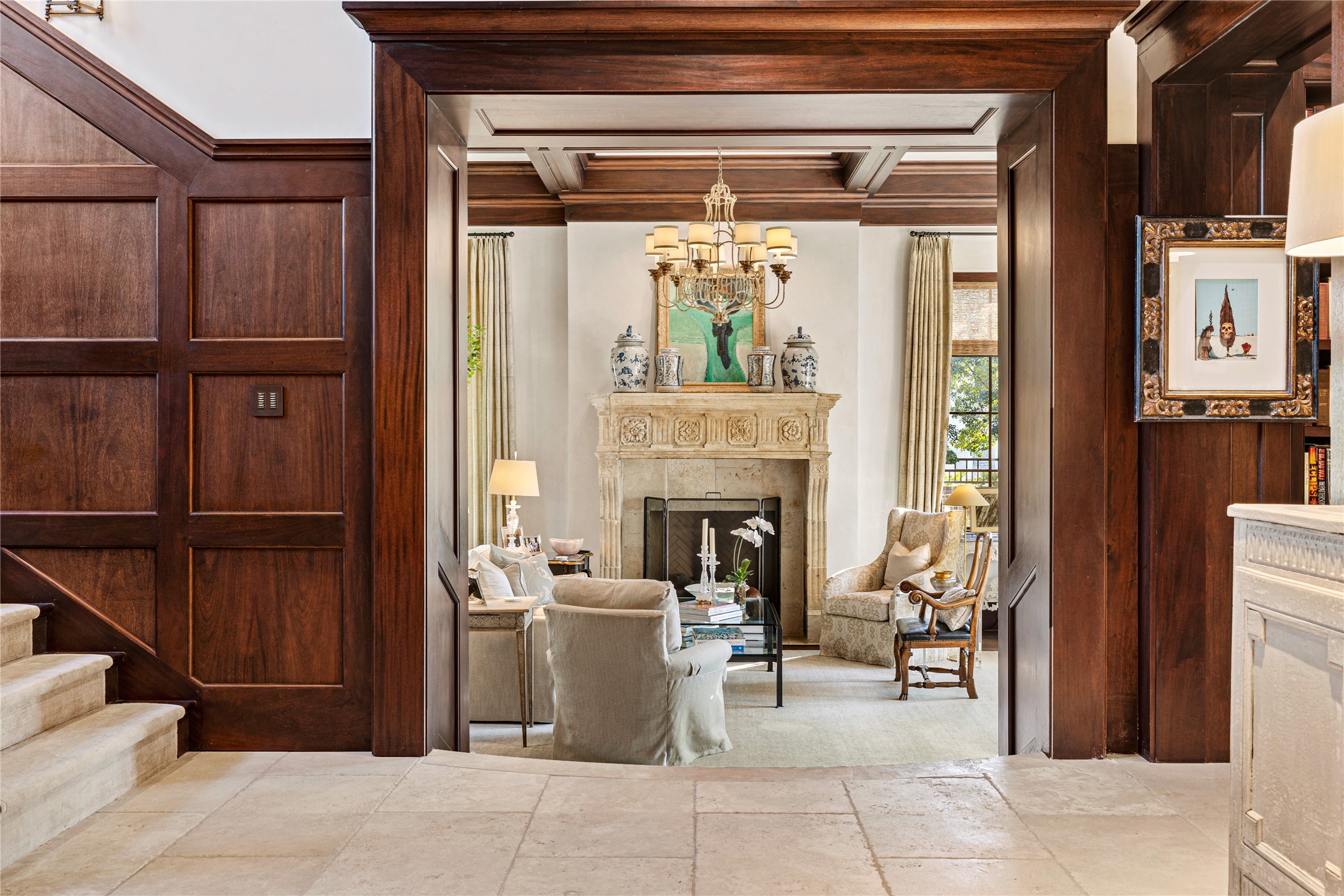 The regal limestone foyer invites you to gather inthe formal living room, flanked by a stone fireplace imported from Italy.