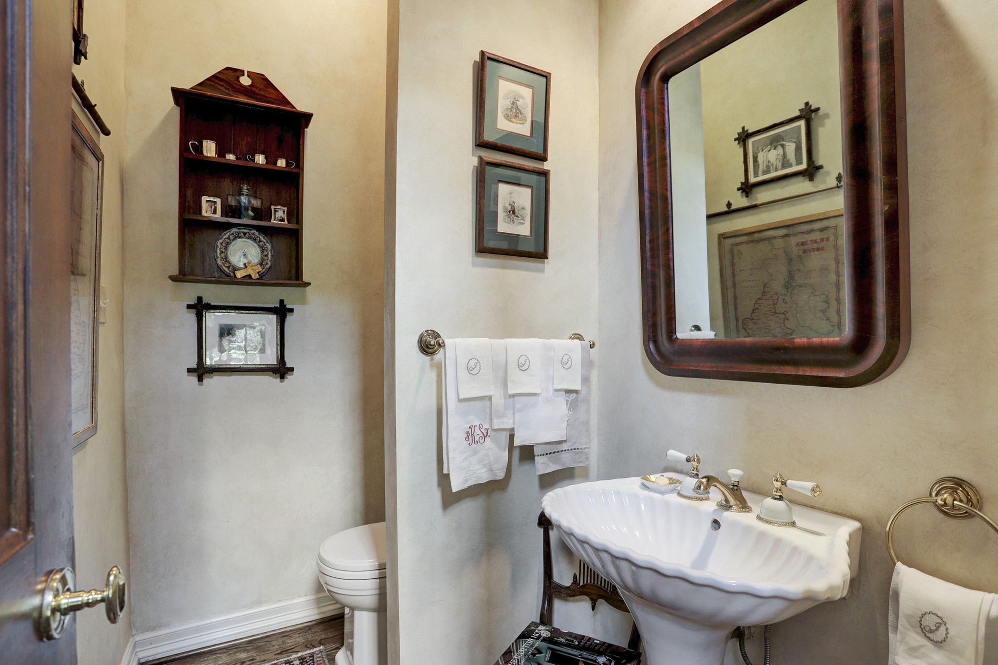 The powder bath is located across from the stairs and reception hall area.