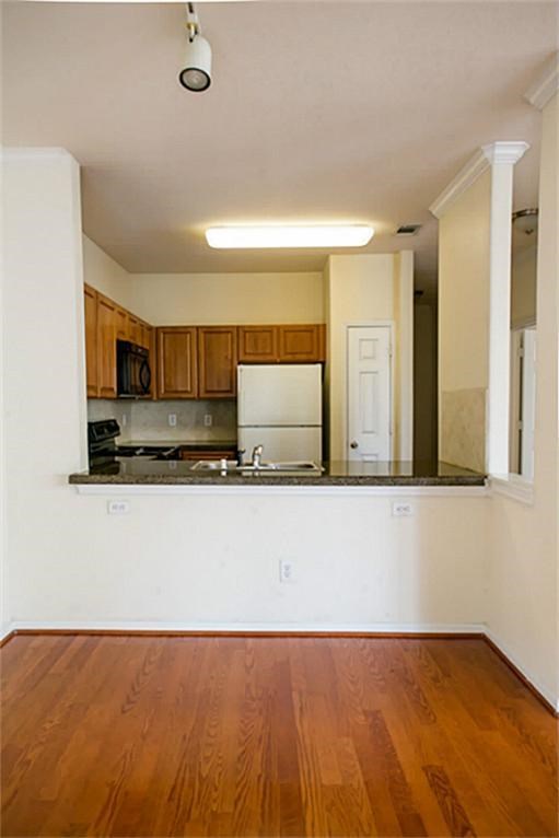 Kitchen with granite countertop and wood floor
