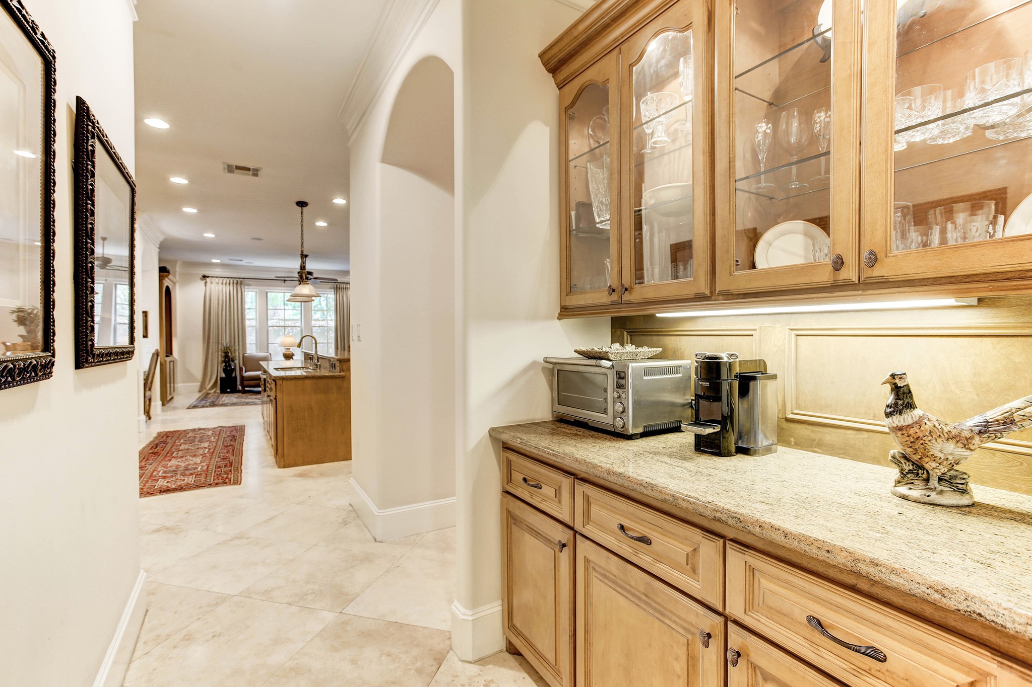 The Butlers pantry conveniently located beyond the Kitchen and very accessible to the dining room.  Lots of glass cabinet storage as well as counter storage.