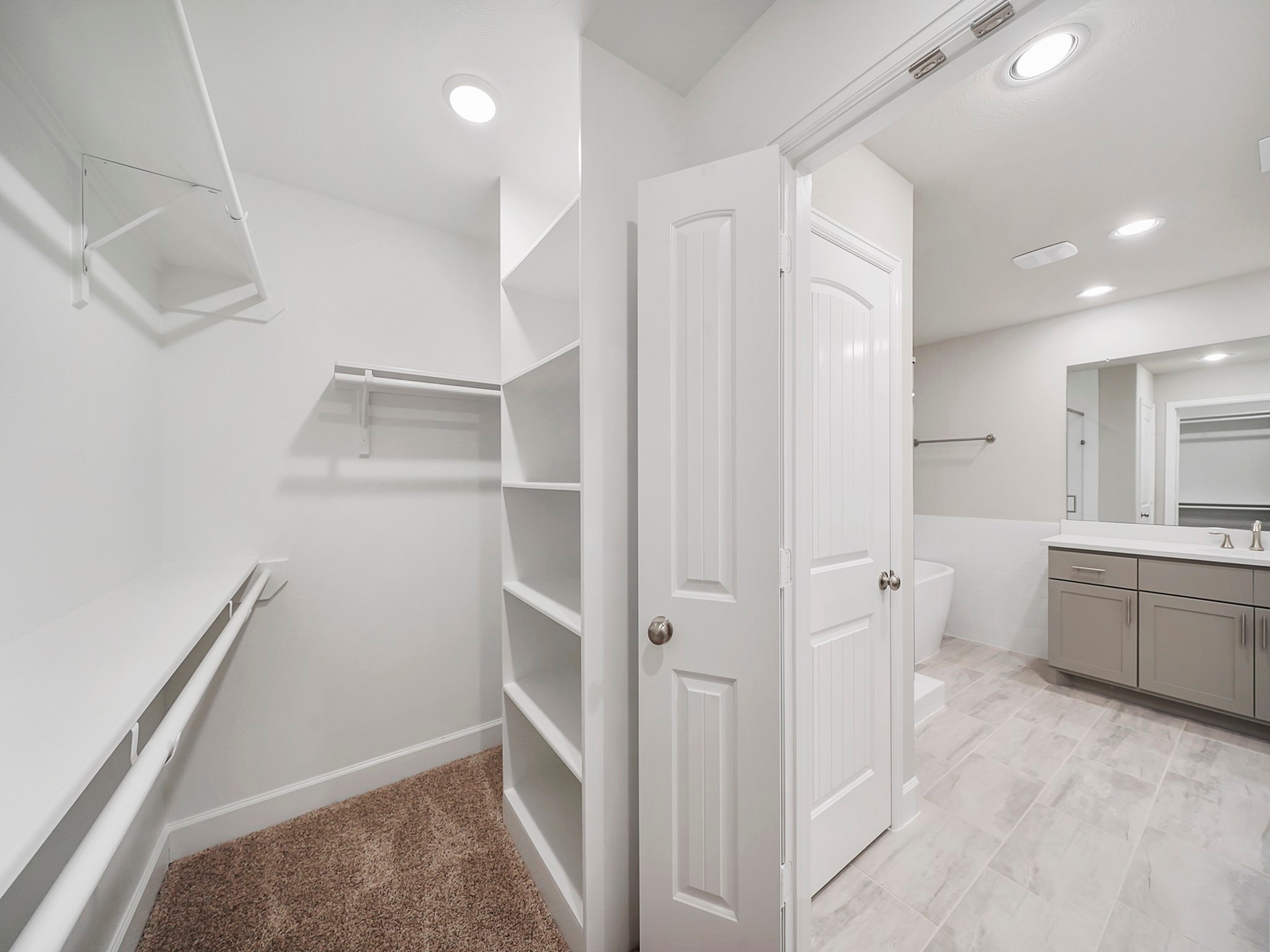The Primary Bedroom Closet is spacious and features built-in shelves for additional storage. (Sample photos of a completed Bordeaux floor plan. The image may feature alternative selections and/or upgrades.)