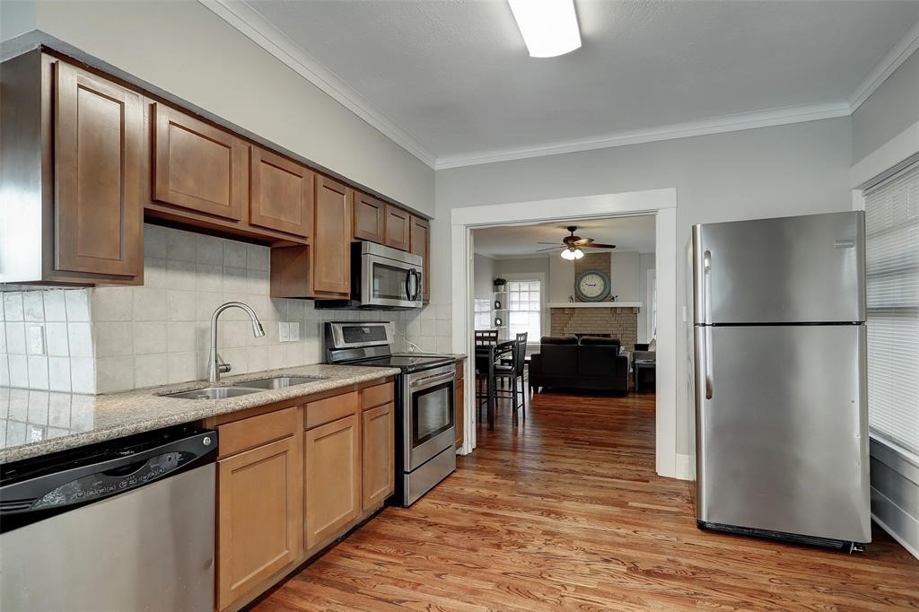 The kitchen features stainless steel appliances and even has enough space for a table or additional storage.