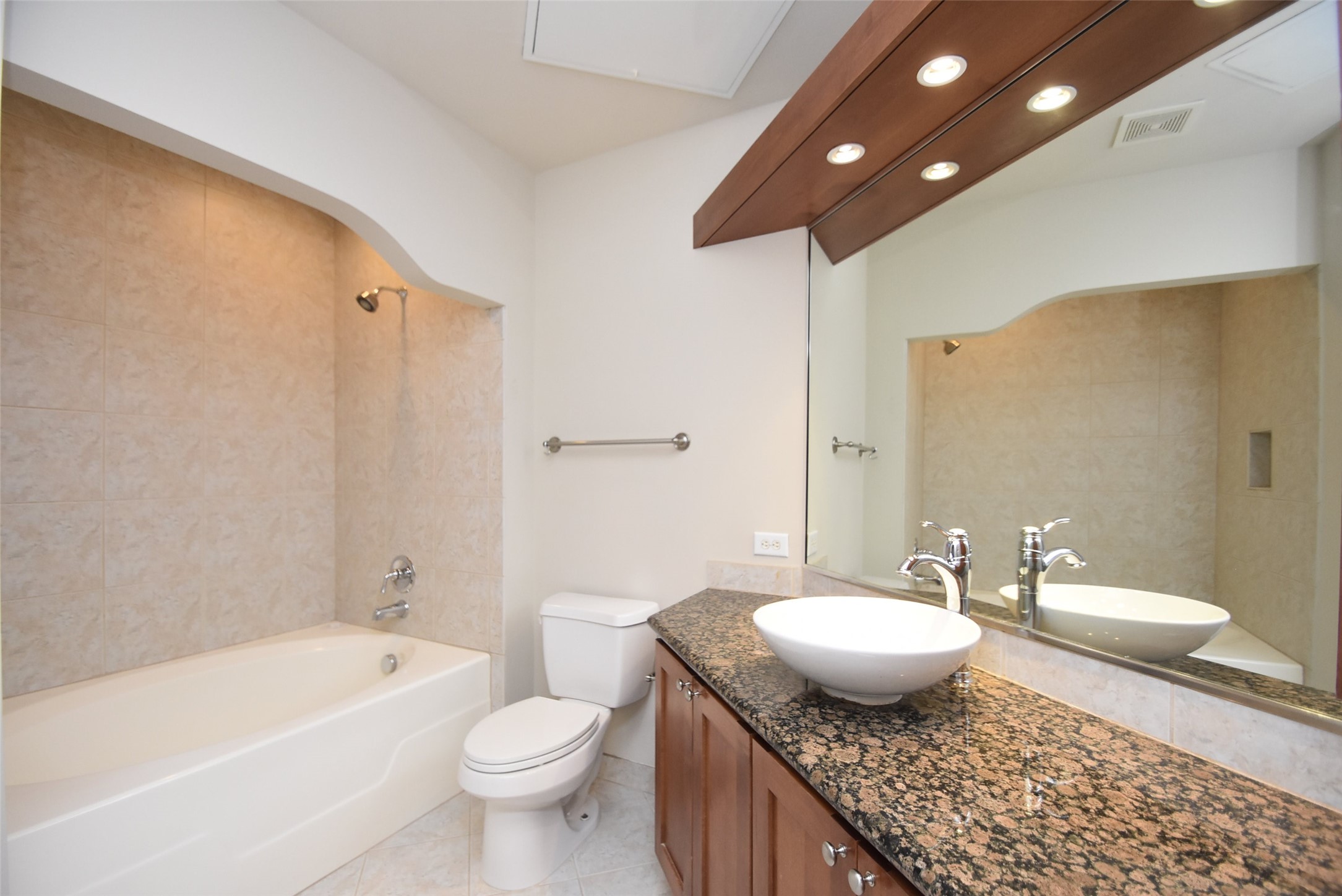 The master bath has a large tub with a shower.