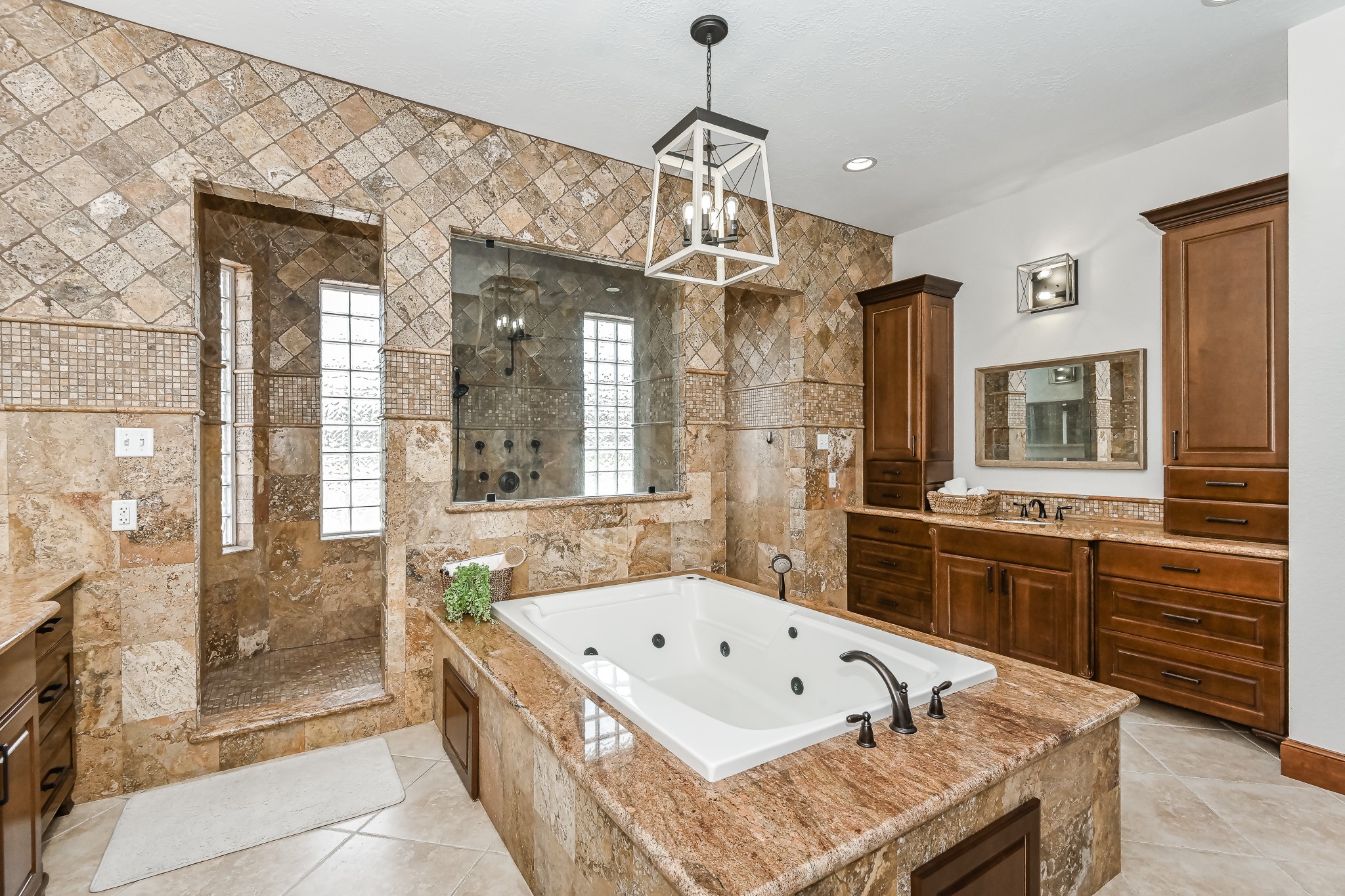Master bathroom with an oversized jetted tub and a walk through double entrance rain shower.