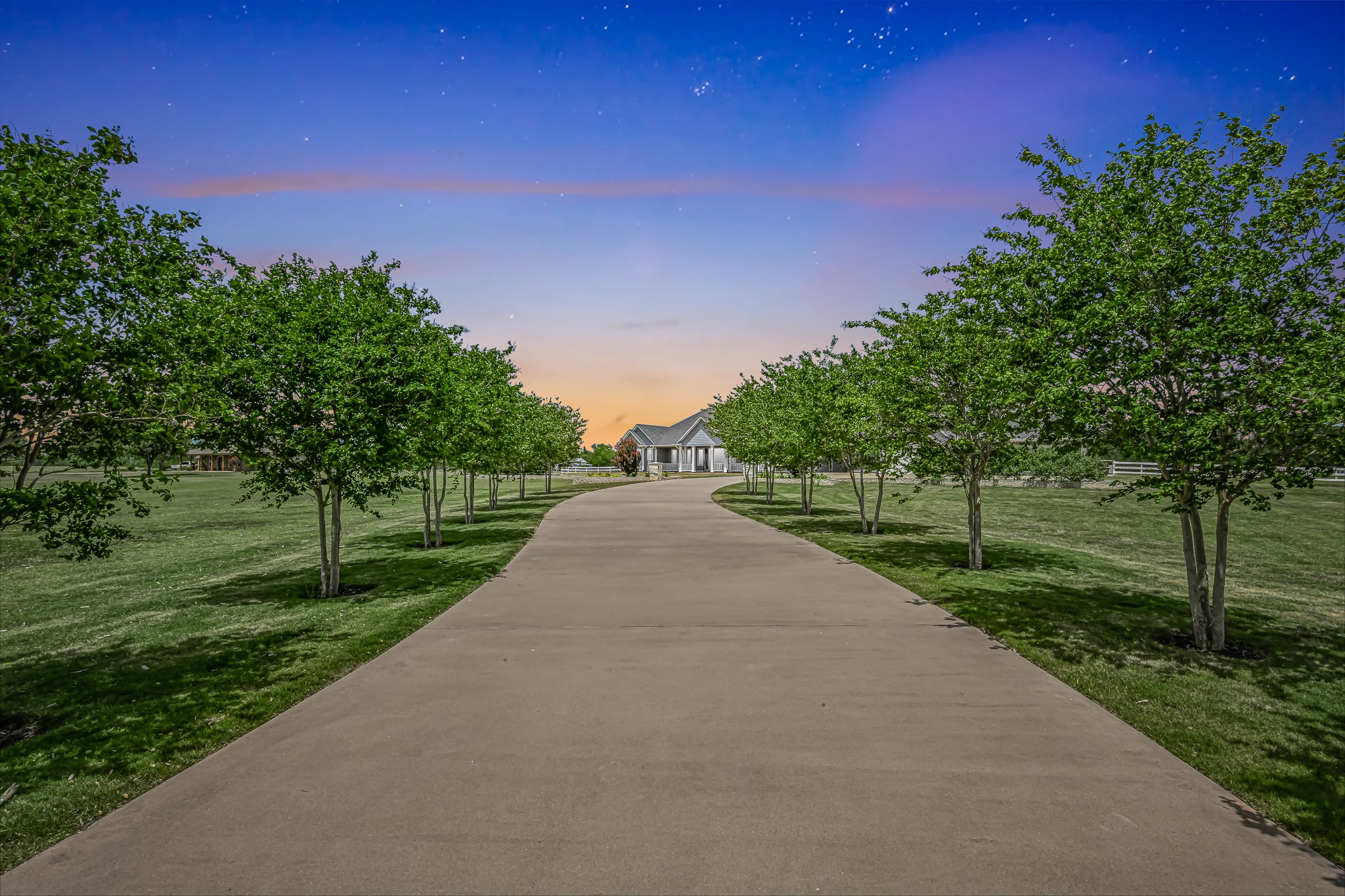 Crepe Myrtle trees line the long driveway as you  enter this property.
