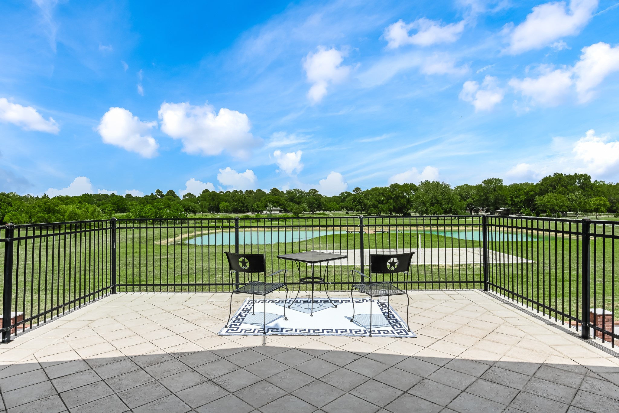 Sundeck overlooking the fully stocked pond and full size sand volleyball court.