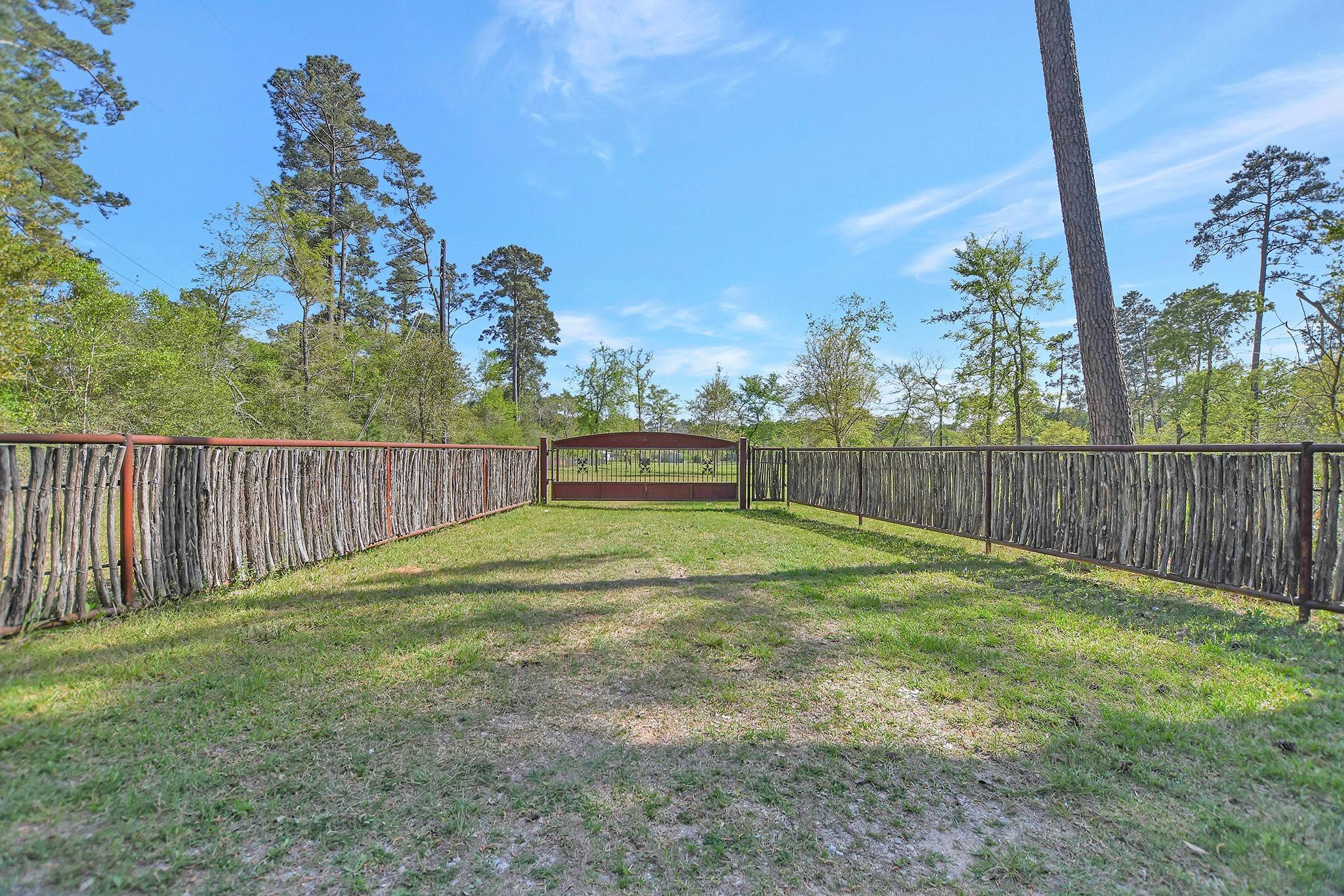 This inviting entry leads to your future 3 +/- acre homesite in Stagecoach Farms.