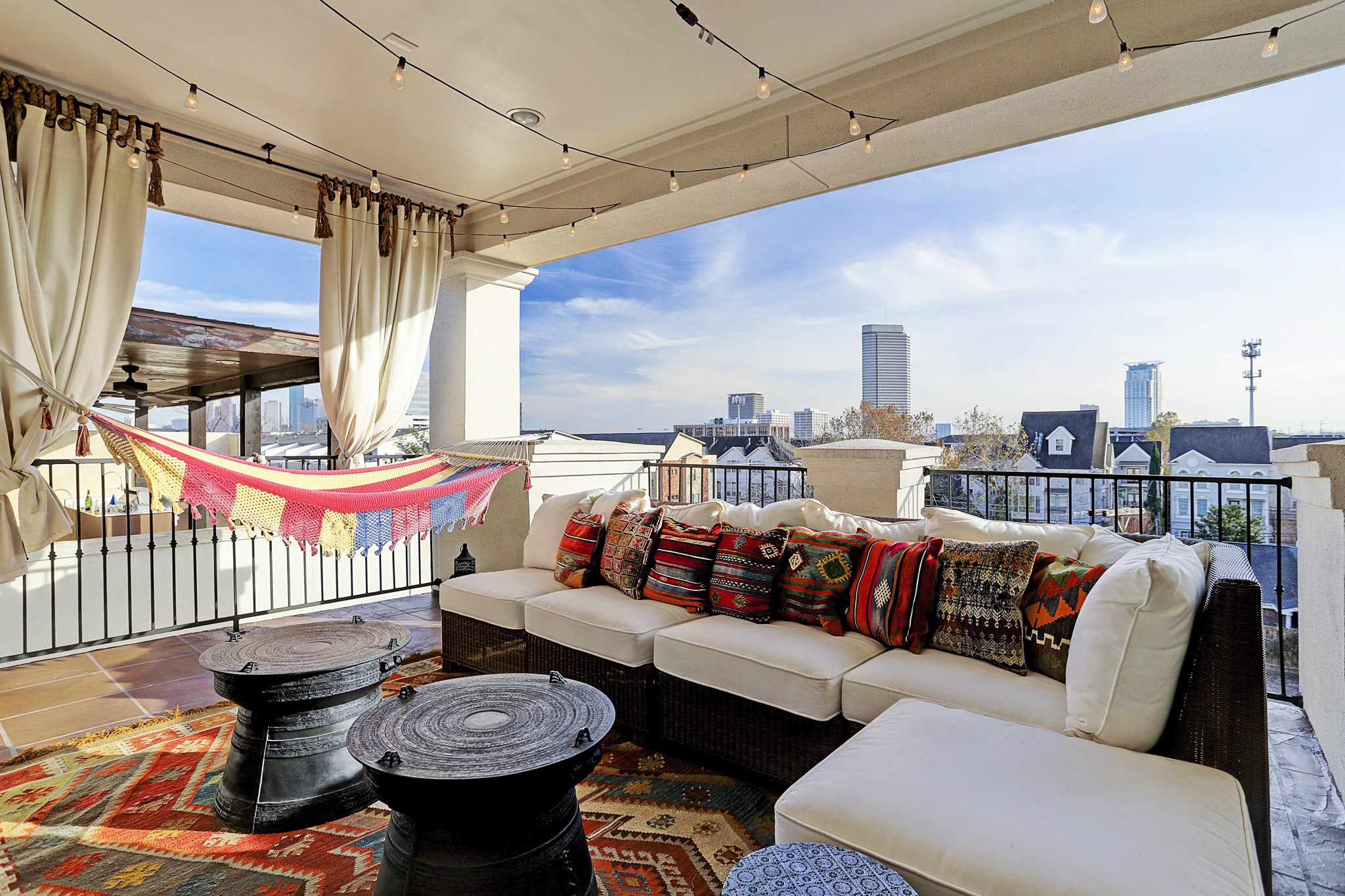 Covered rooftop patio with views of downtown. Party lights will remain.
