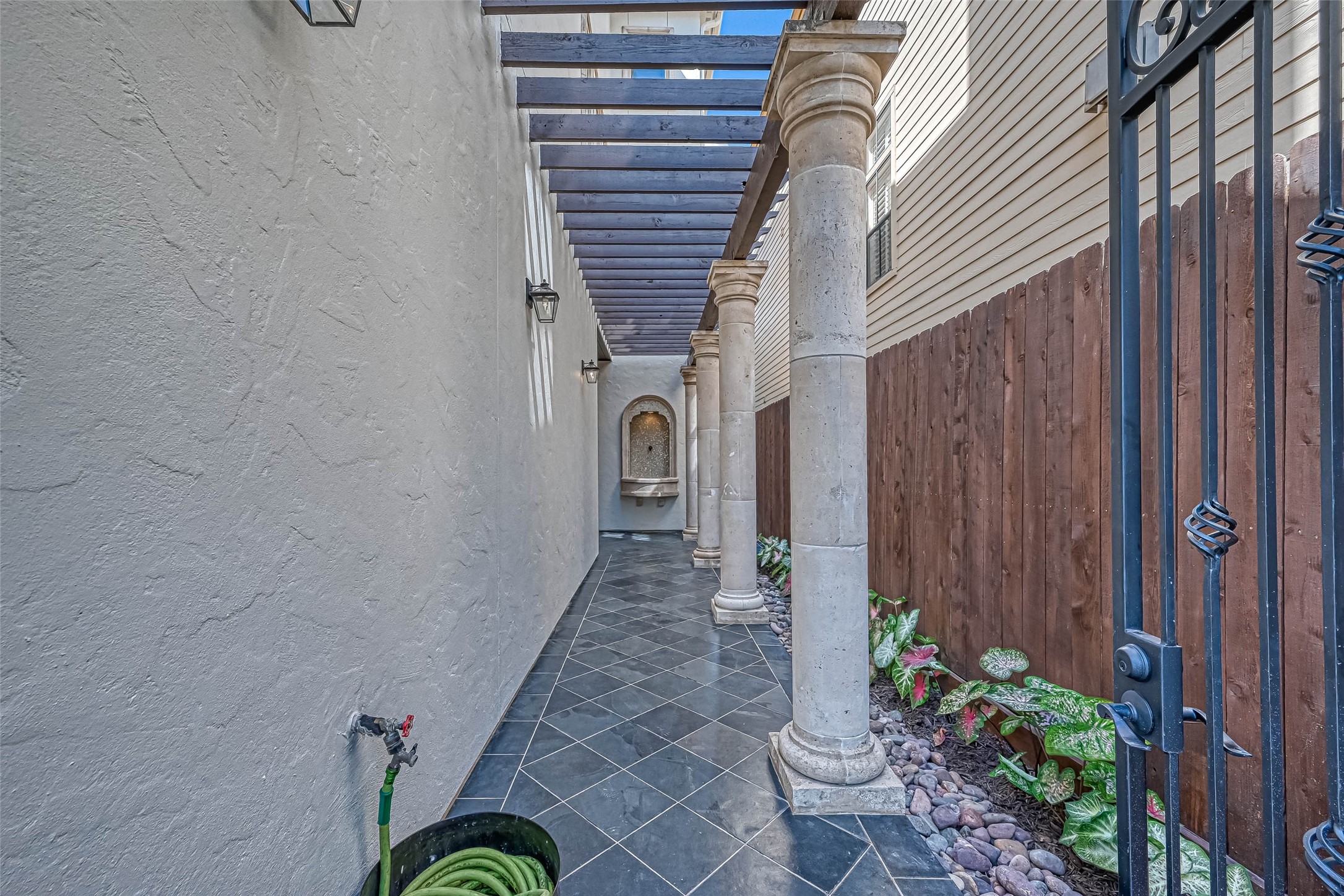 Walk way with columns and slate leading to the front door