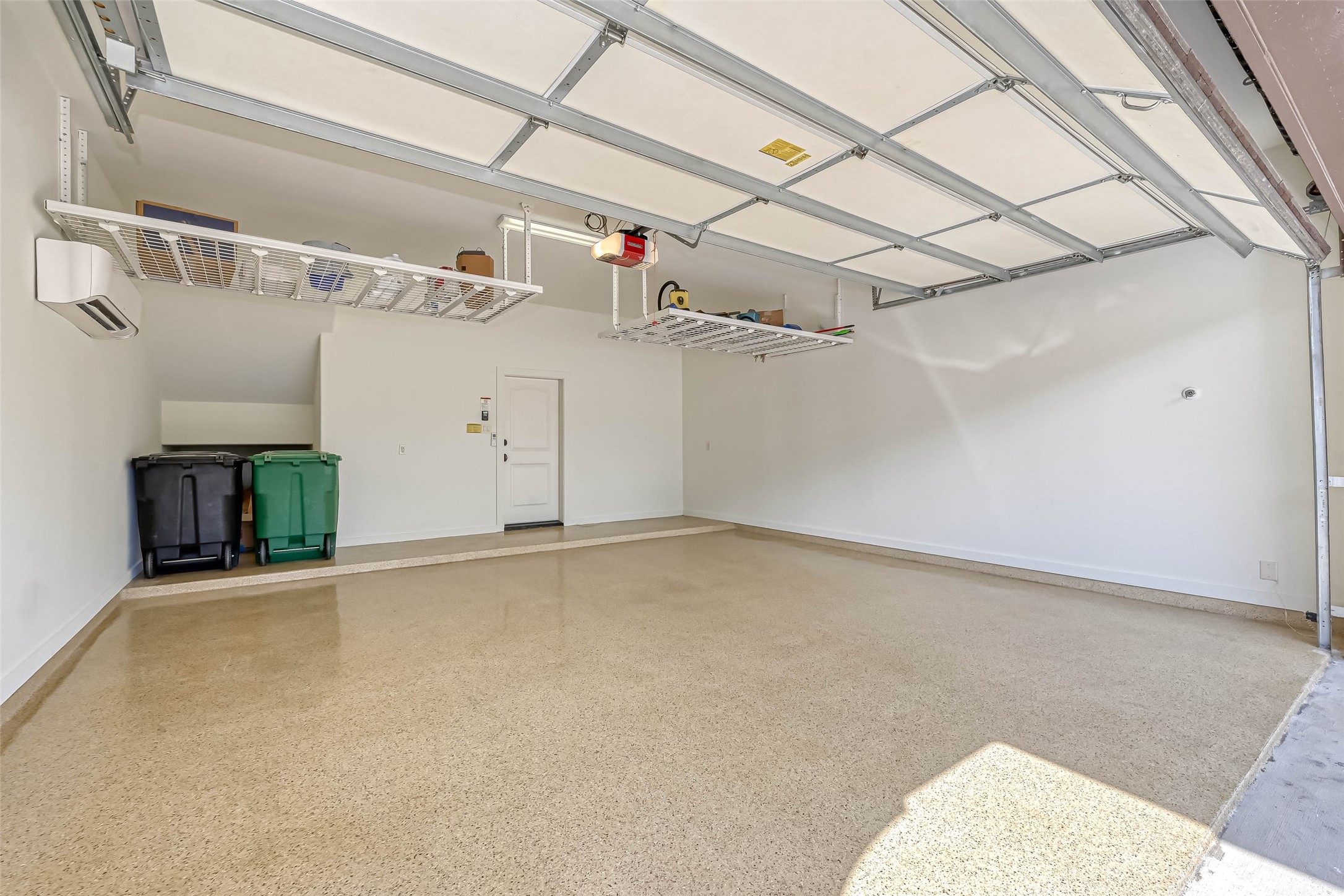 Garage has epoxy flooring, above storage and is air conditioned