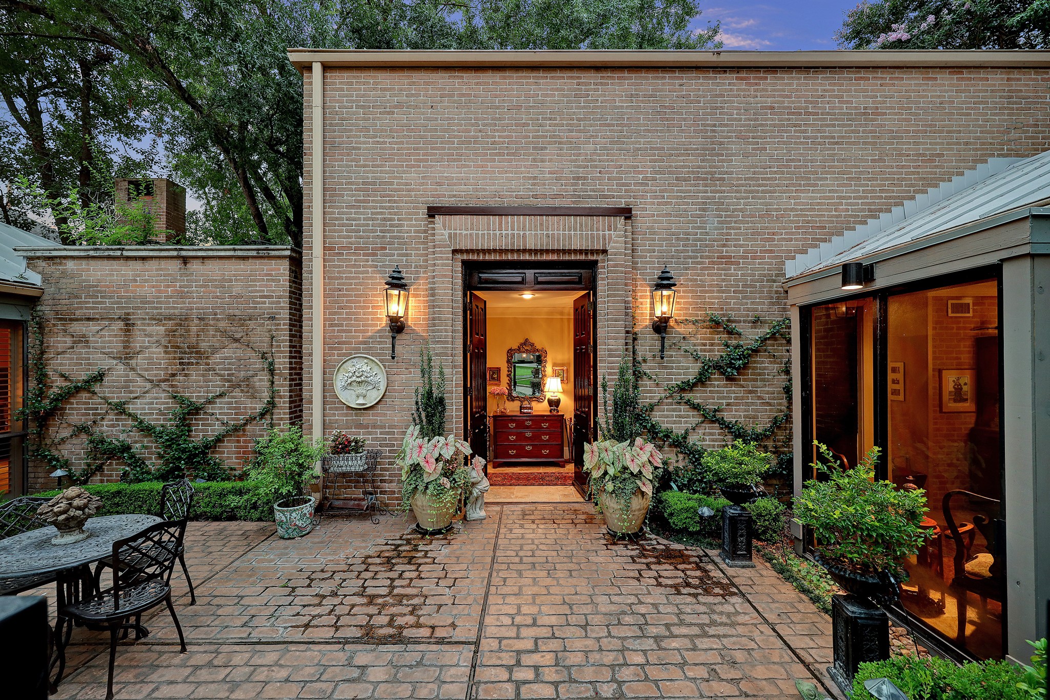 Private courtyard with massive solid wood double door entry to home.