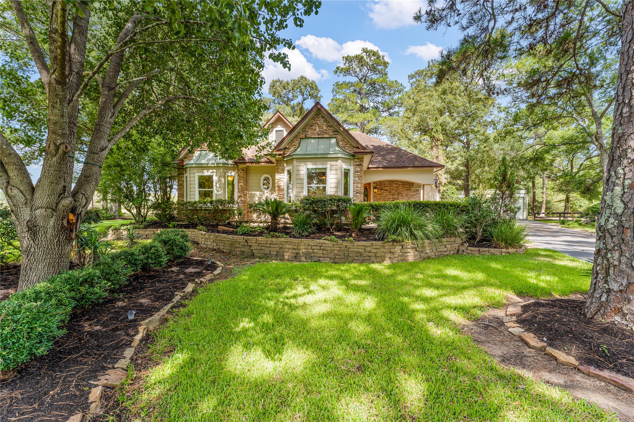 Tucked away on a beautiful country road known for luxury properties on acreage, & less than an hour from downtown Houston is 22388 Murrell Road in Hockley, Texas