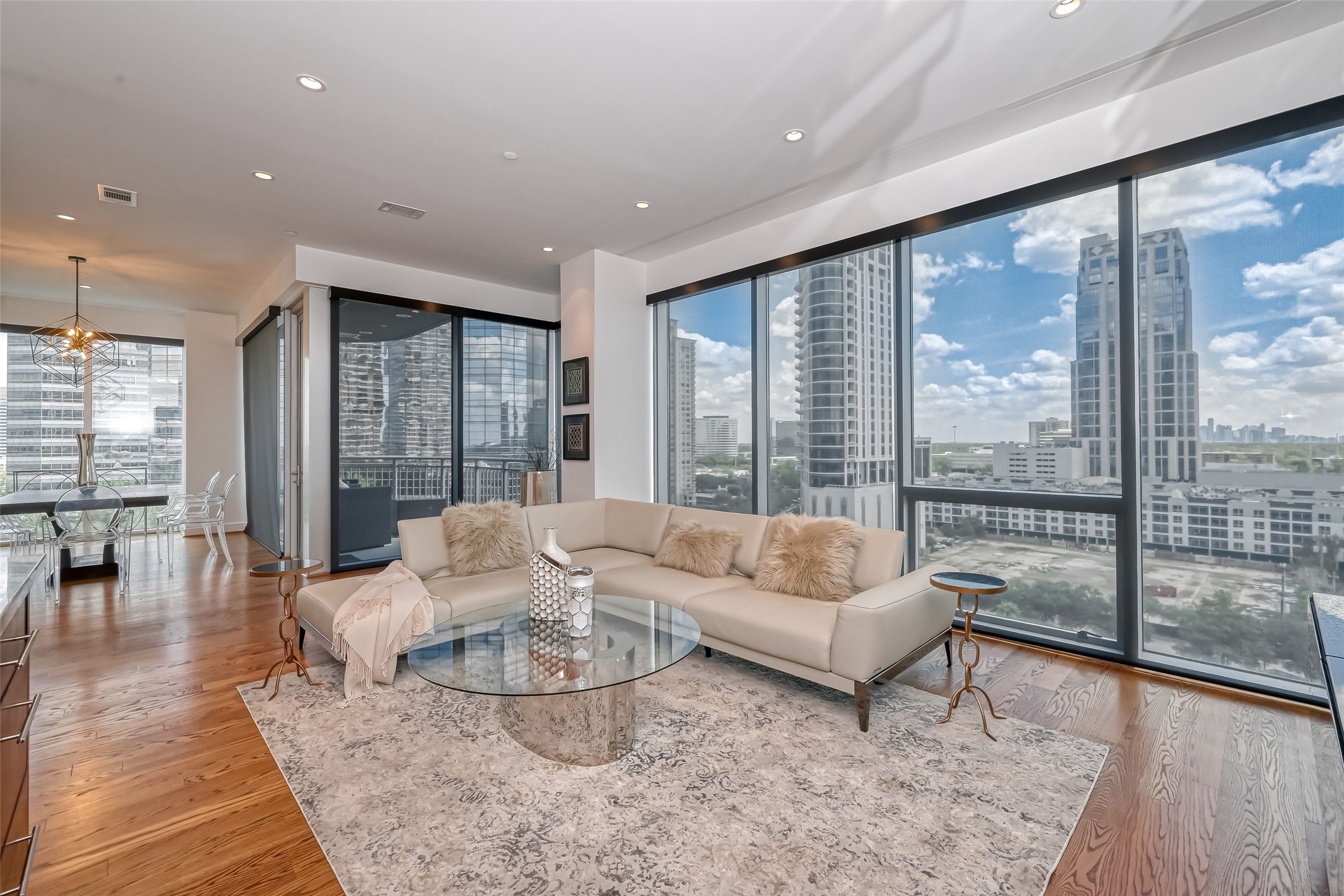 Surrounded by walls of windows with automatic shades providing exquisite views, this beautiful open concept unit features a spacious Family Room which opens to the Kitchen and Dining Room and features hardwood floors.
