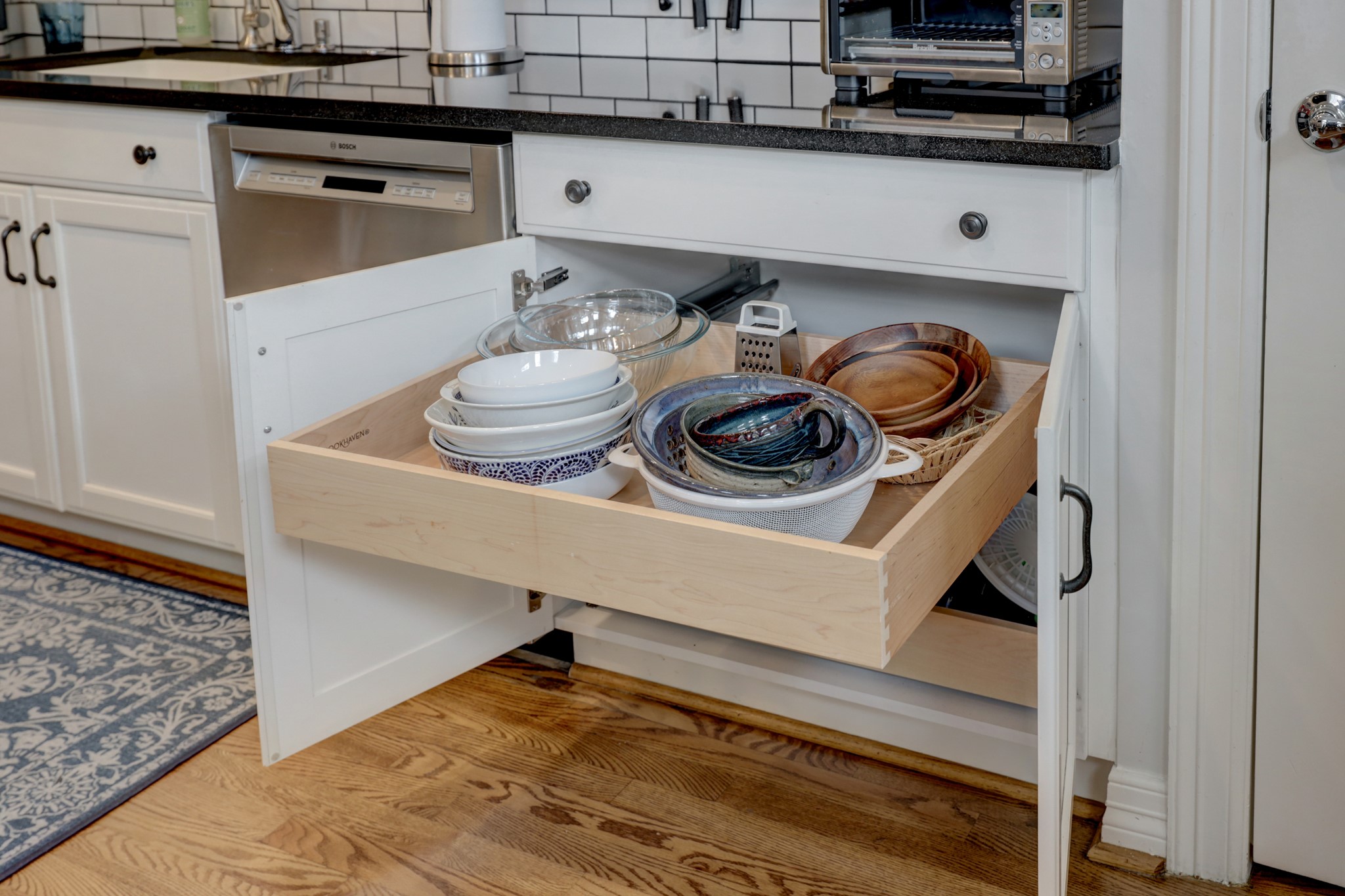 The pull out drawers in the kitchen allow you to easily organize and reach your pots and pans.